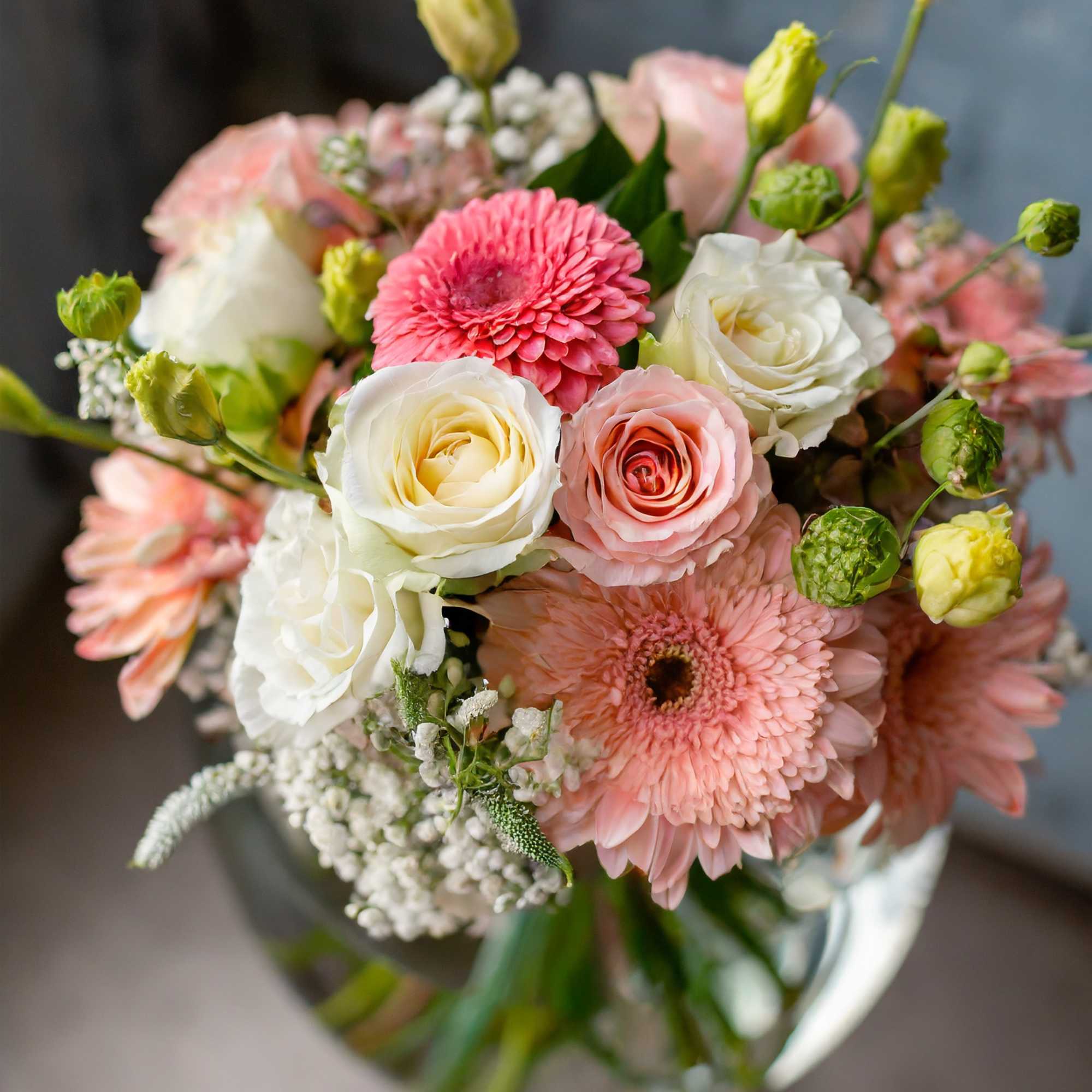 A charming and beautiful bouquet in a clear vase, featuring a delightful