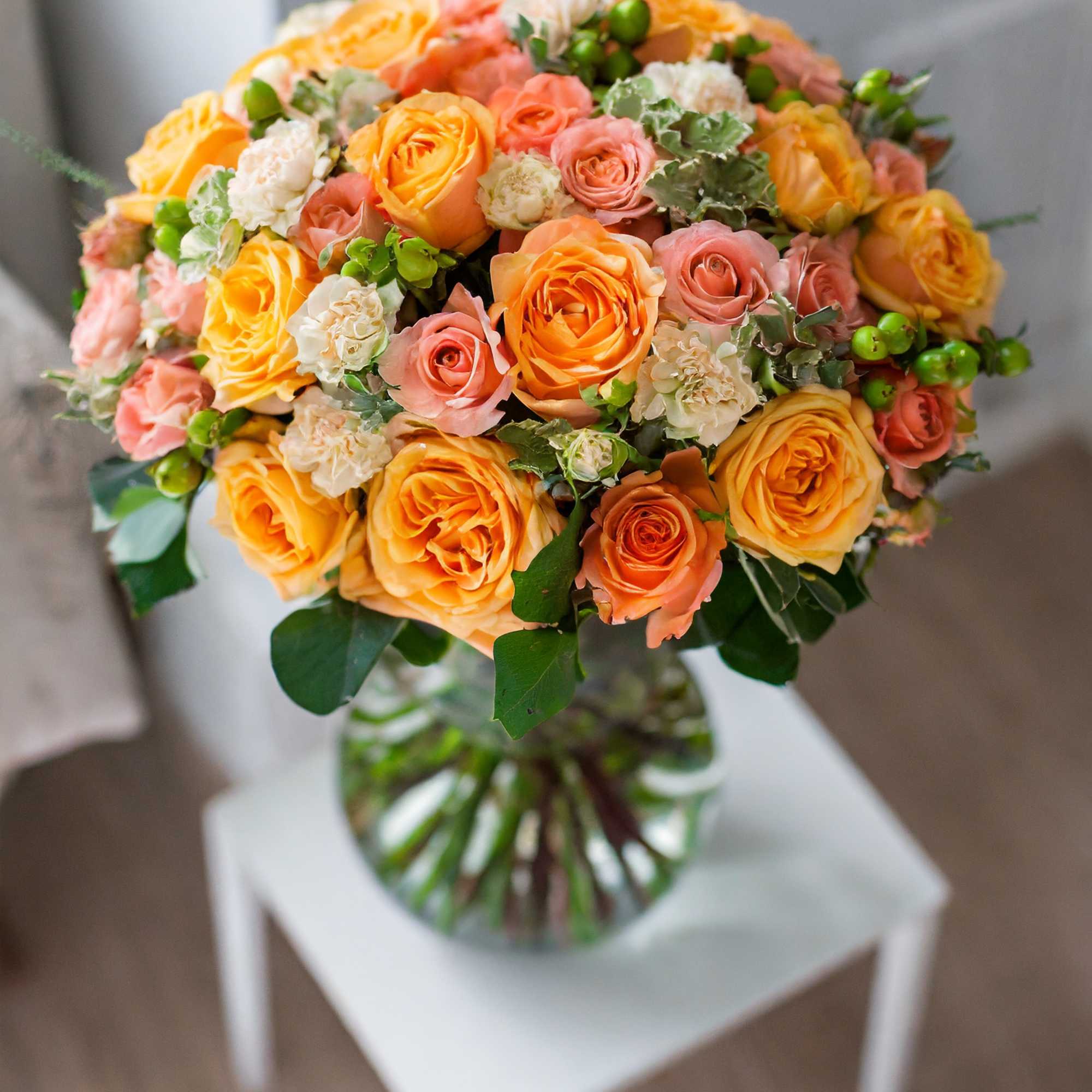 A breathtaking arrangement of flowers in a soft orange palette, creating a