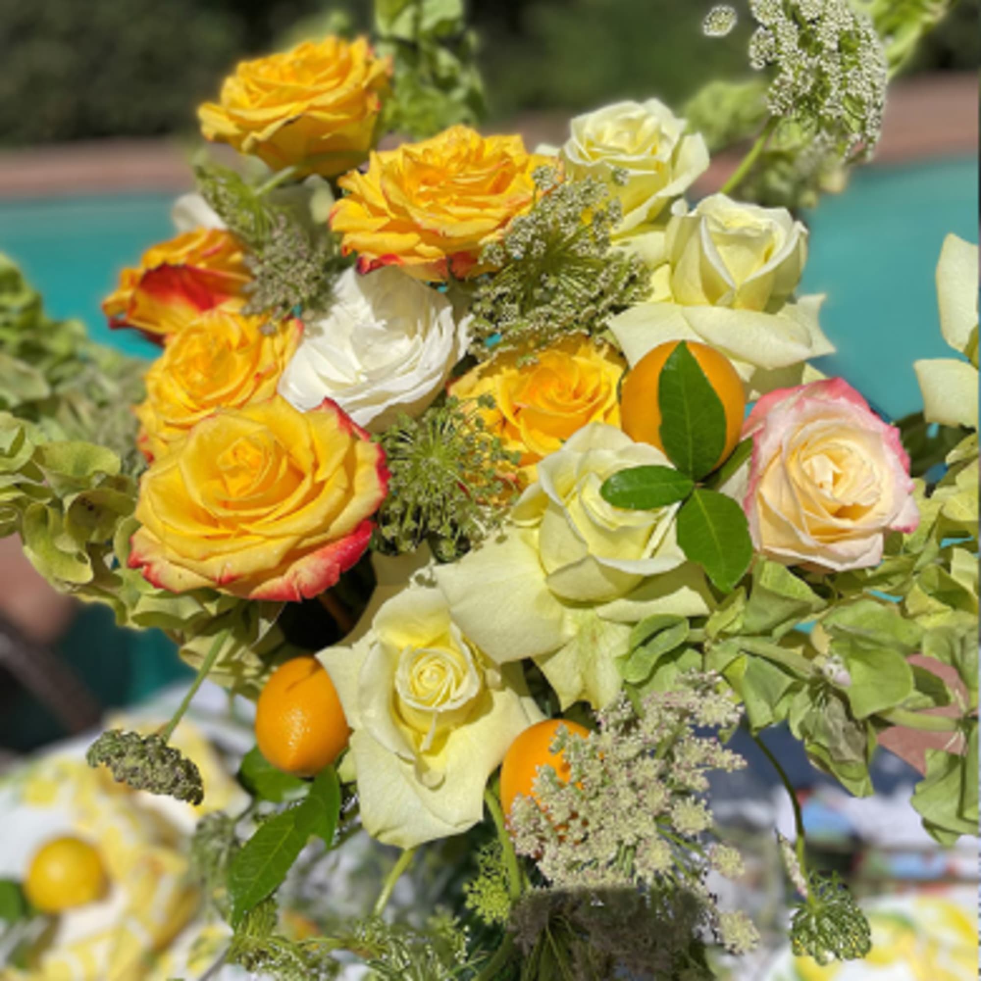 This expressive floral composition with orange and yellow blush roses will create