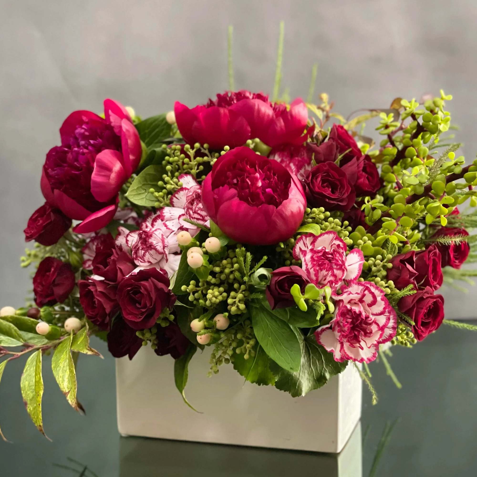 This petite ceramic box includes fresh peonis, spray roses, dutch carnations, coffee