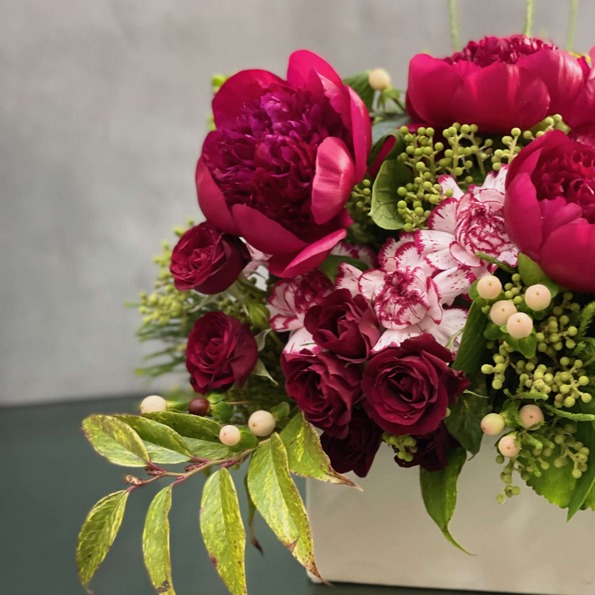 This petite ceramic box includes fresh peonis, spray roses, dutch carnations, coffee