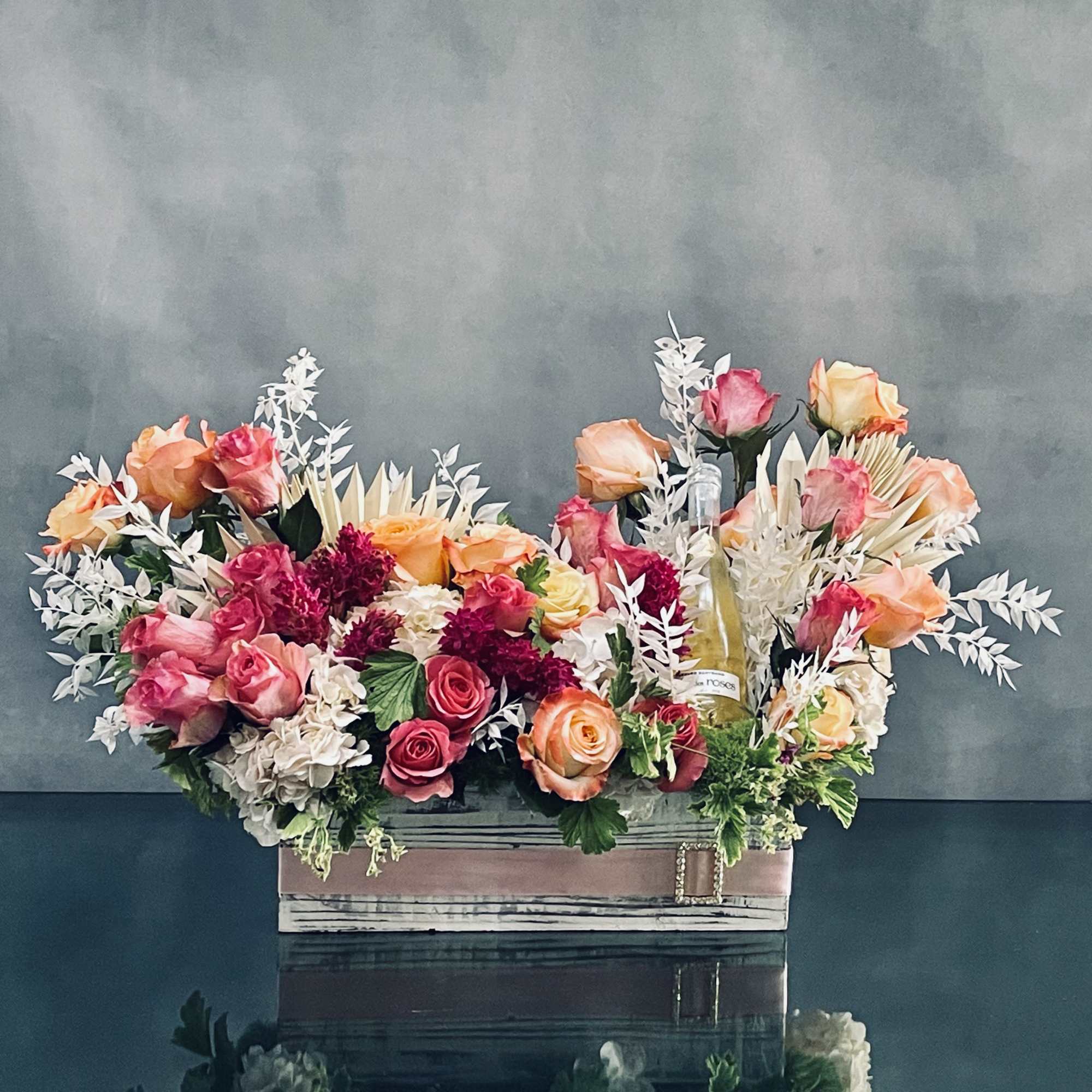 A beautiful presentation of a lovely box of floral which includes, peach