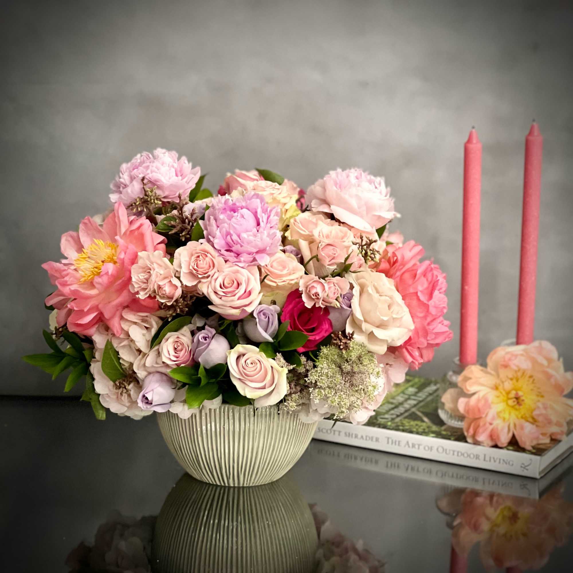 This round dish is abundantly filled with lovely Roses of varying hues