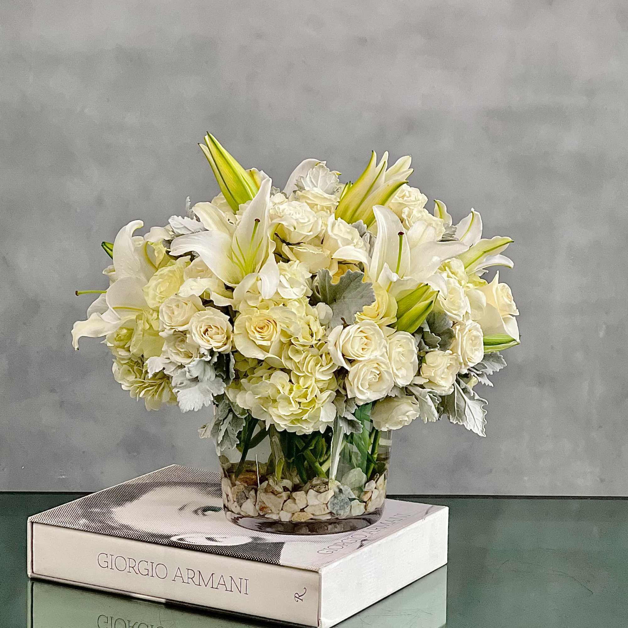 This dreamy white floral mix is heavenly. The cylinder glass vase holds