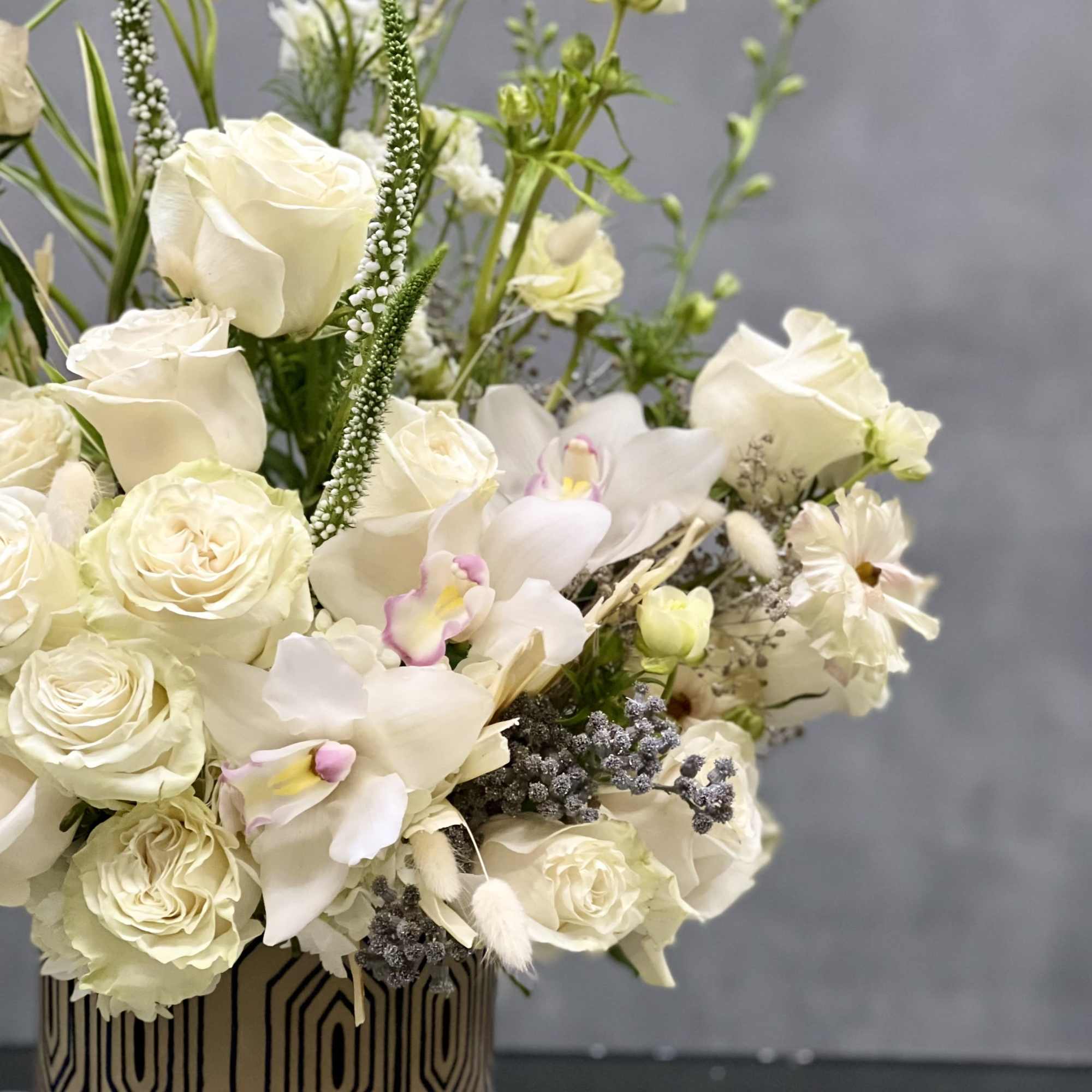 This arrangement is made with a designer&#039;s choice array of seasonal white
