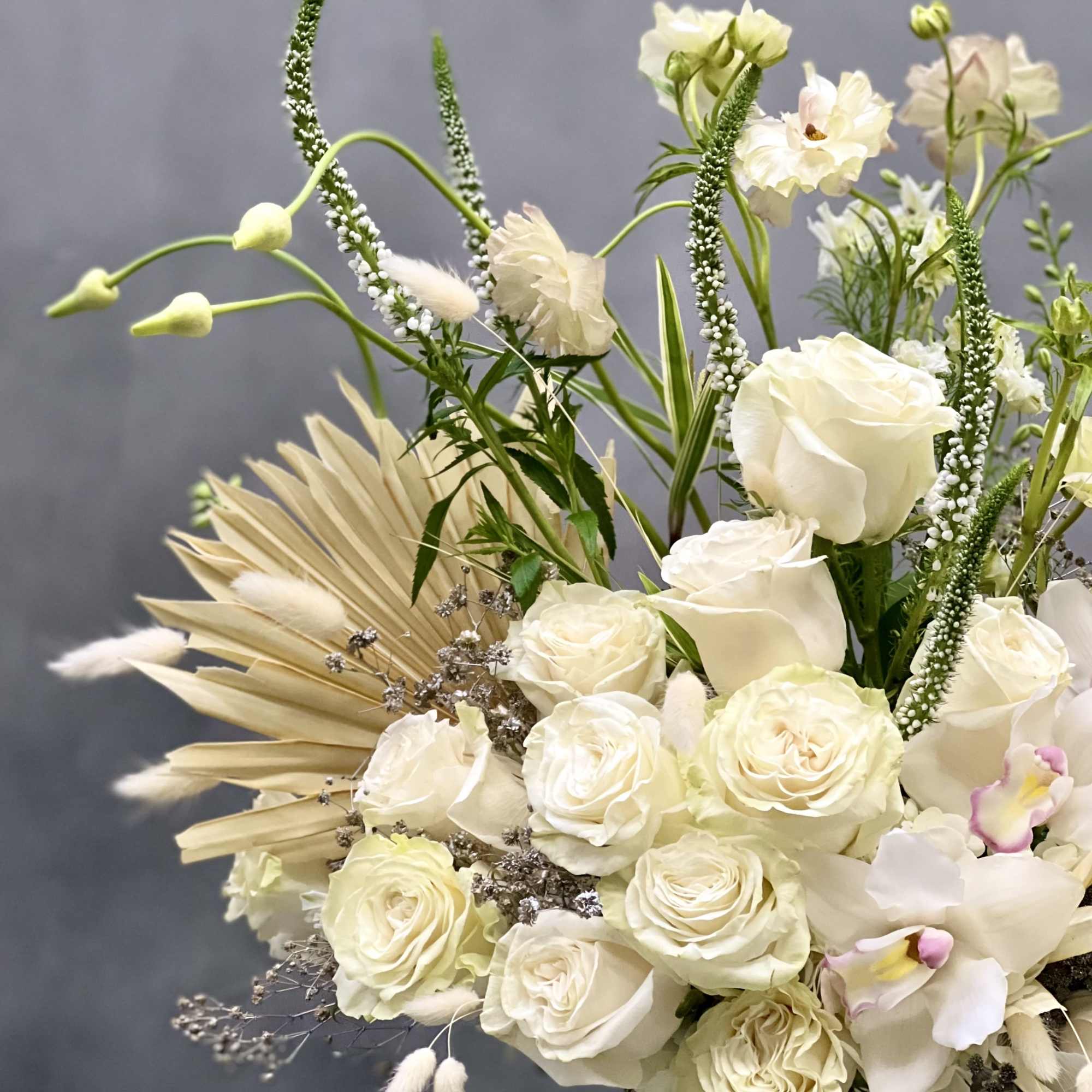 This arrangement is made with a designer&#039;s choice array of seasonal white