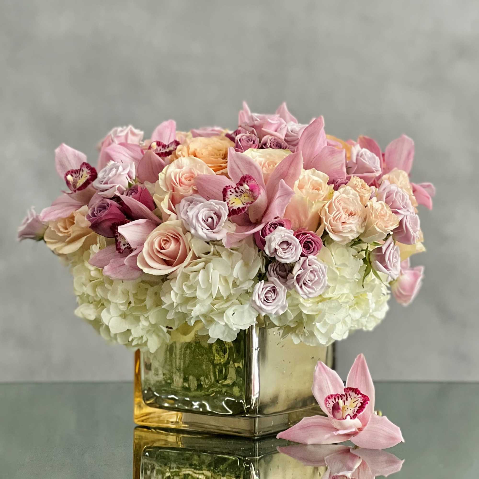 A beautiful array mixed flowers that include Roses, Orchids and Hydrangeas in