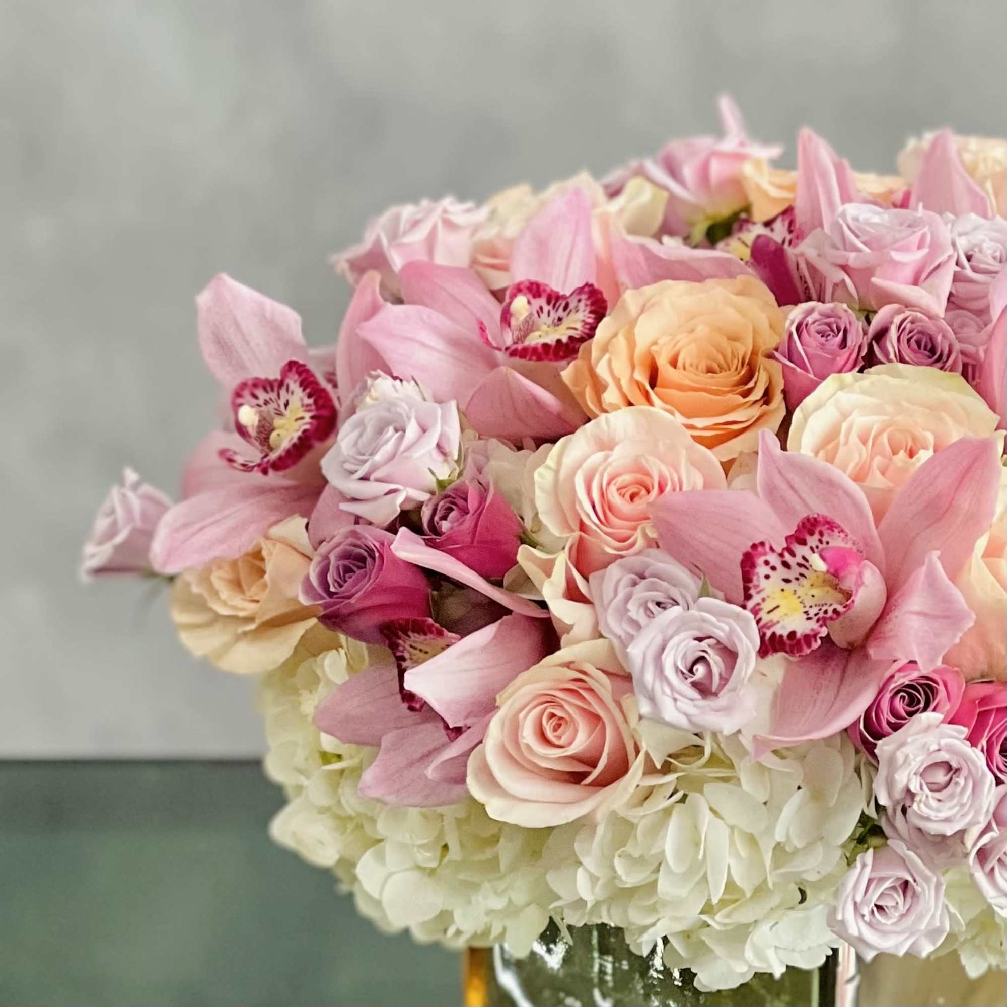 A beautiful array mixed flowers that include Roses, Orchids and Hydrangeas in