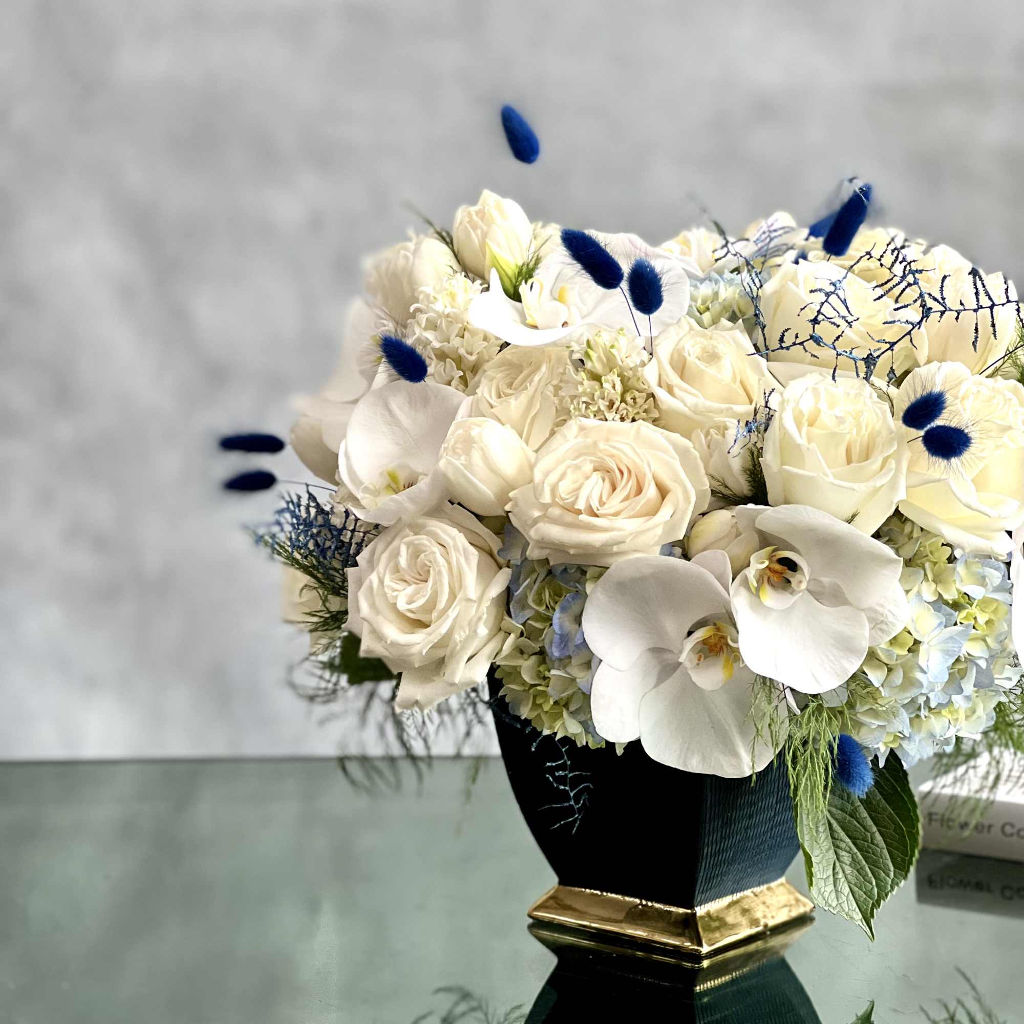Delicate white Roses with white orchids, and hyacinths mixed with the texture