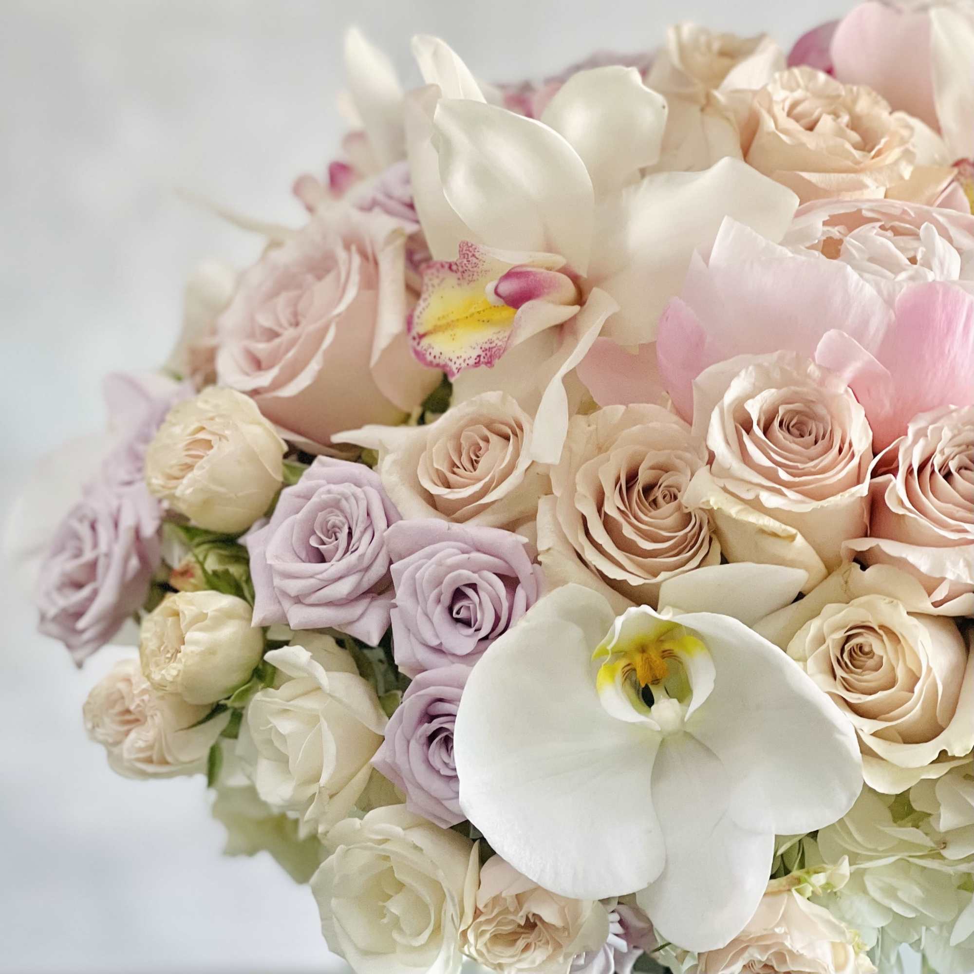 This beautiful array of light pink peonies, pink roses, lavender and light