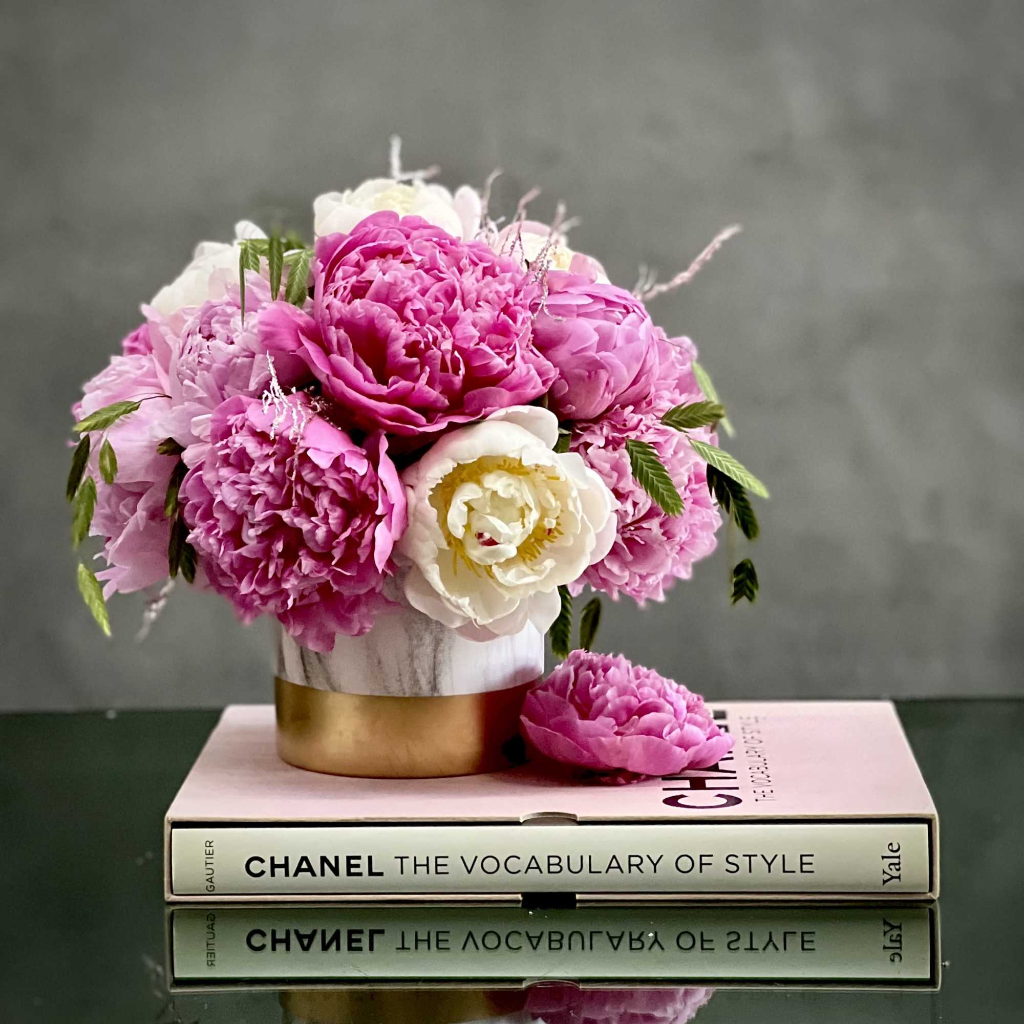 Peonies layered over delicate leaves ready for same day delivery. let our