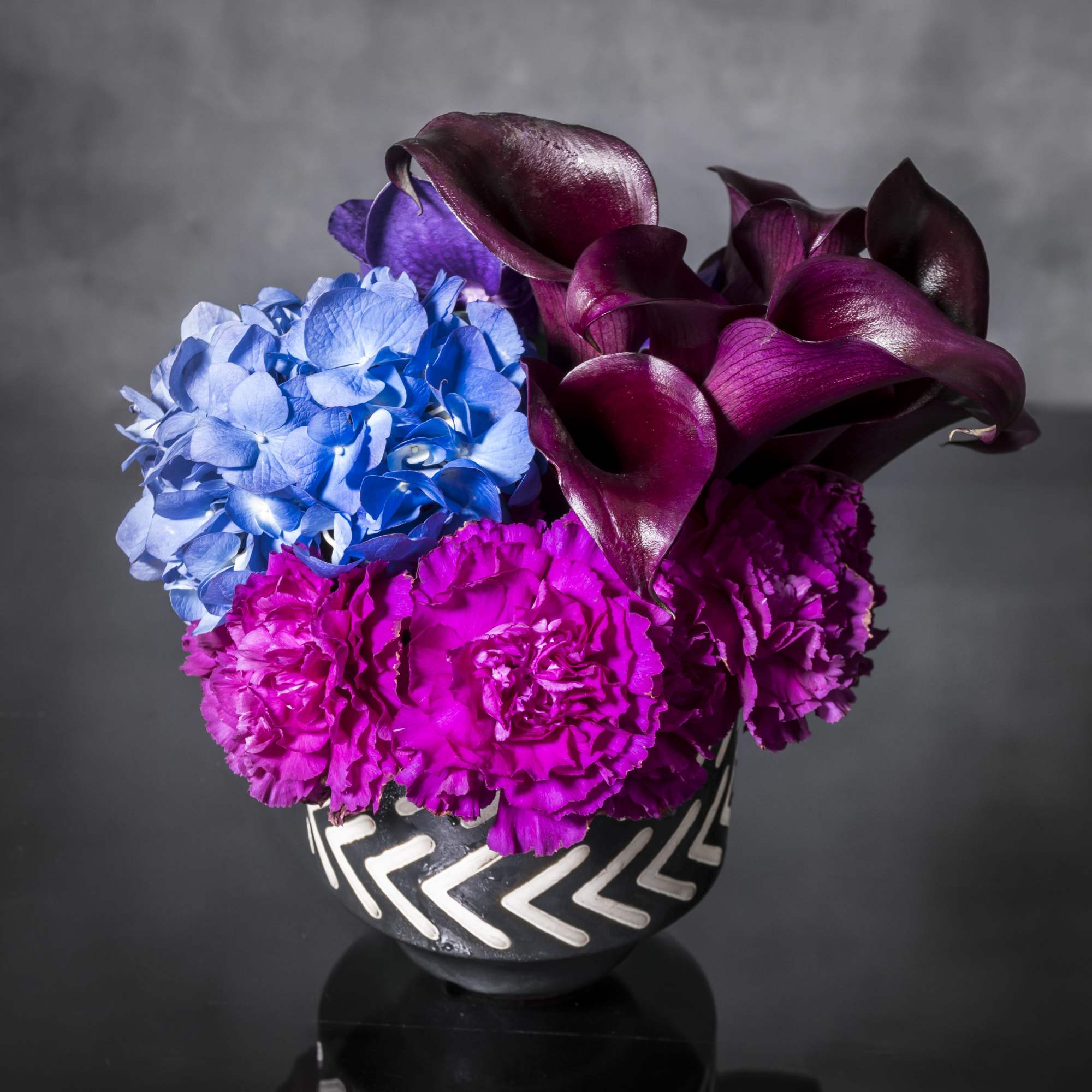 Oooo-la-la! Lavish and lovely, this assortment of specialty florals in shade of