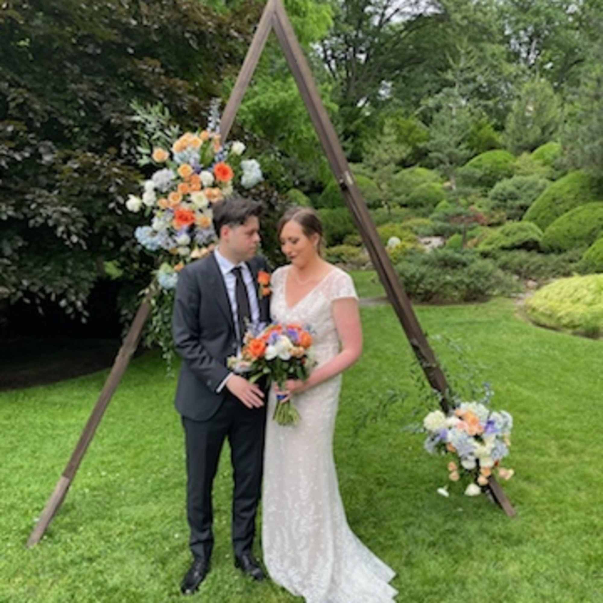 Beautiful mix of orange, blue and white flowers with the fillers and