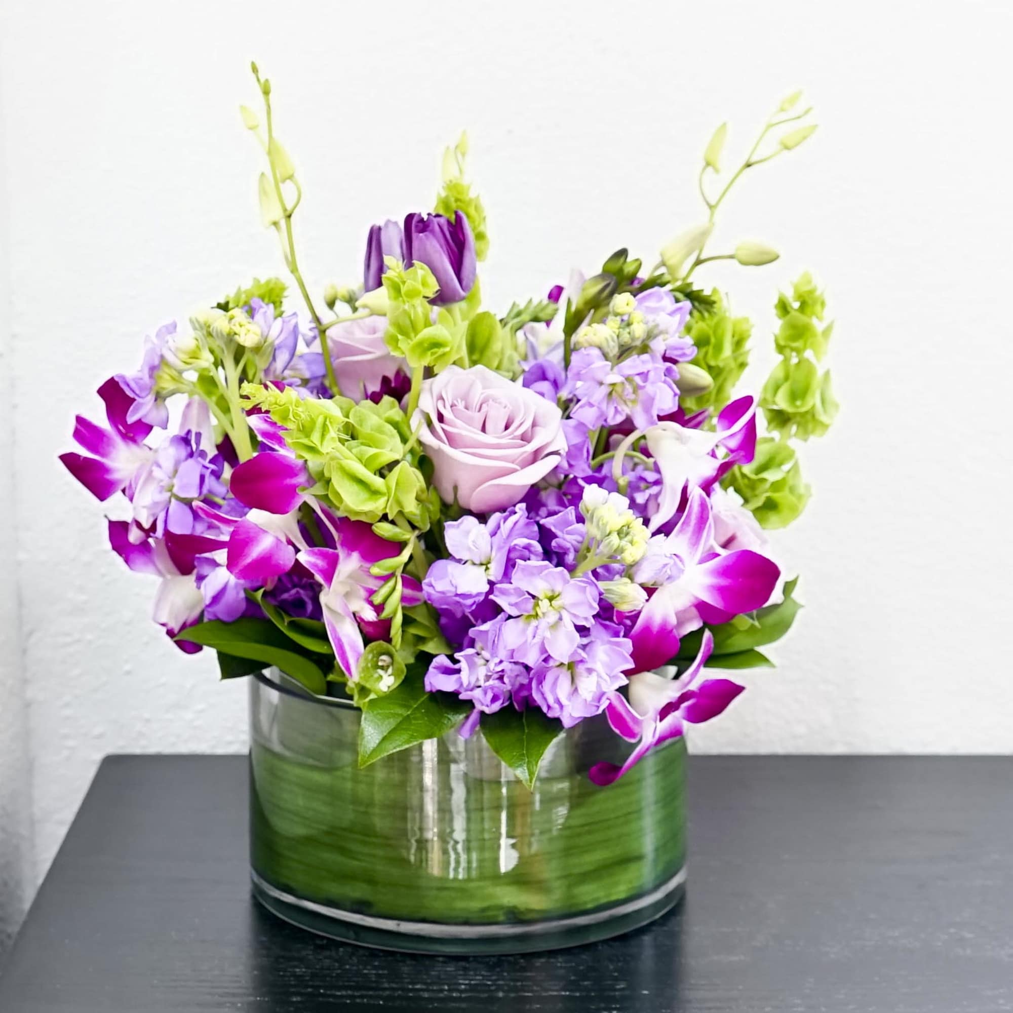 A beautiful mixture of lavender roses, white or purple tulips, bells of