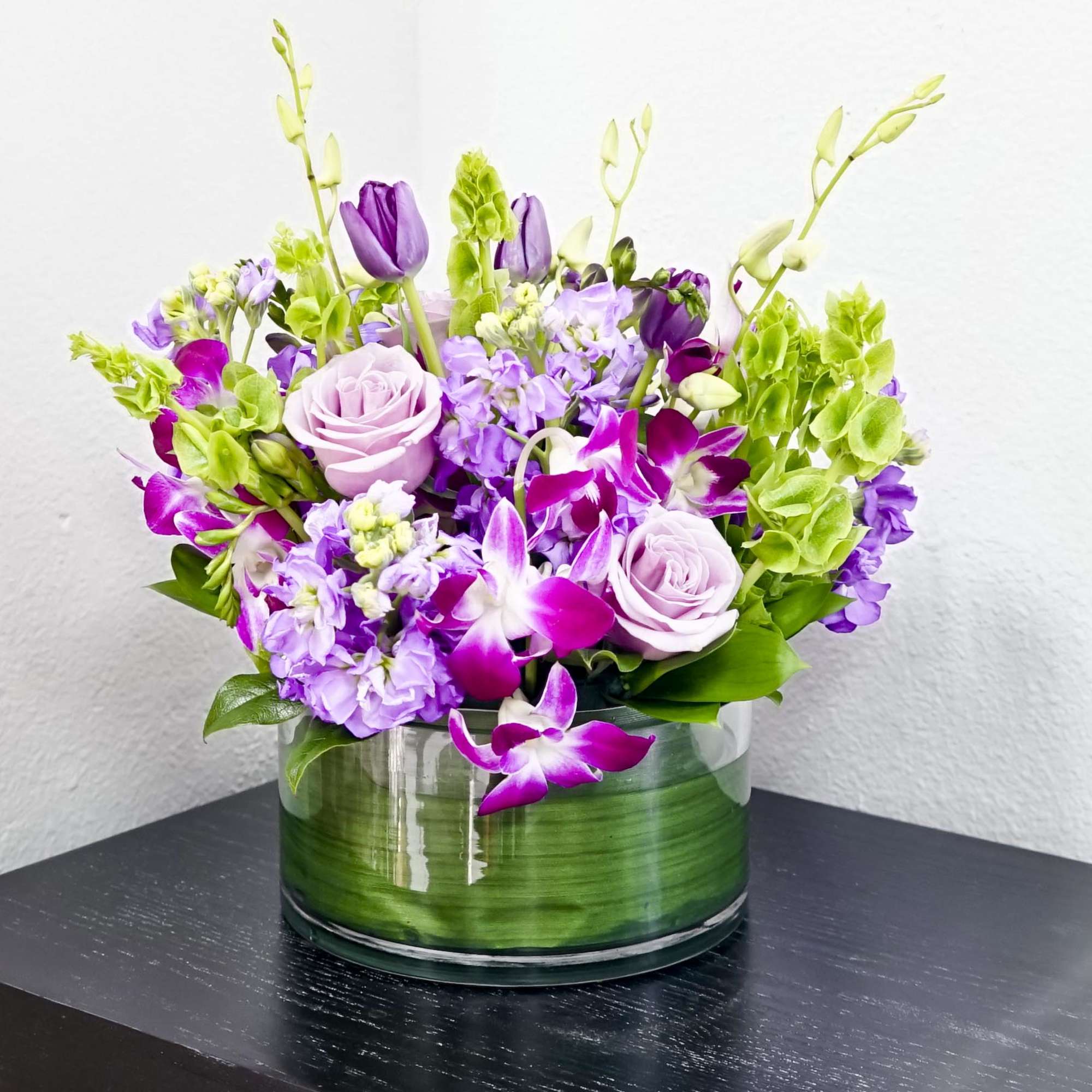 A beautiful mixture of lavender roses, white or purple tulips, bells of