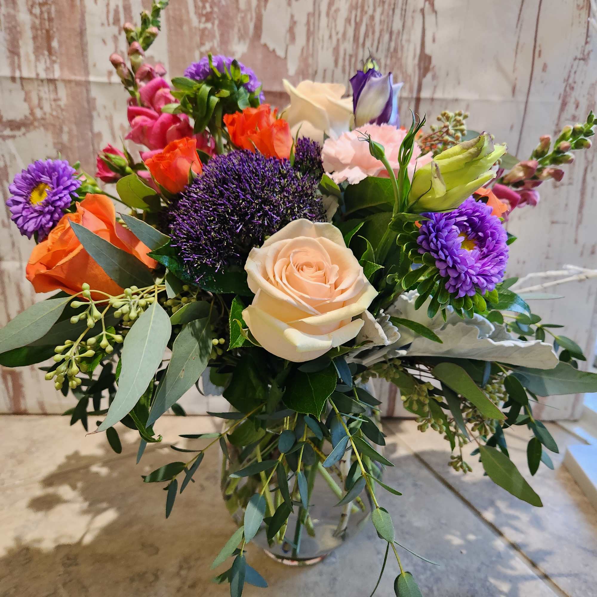 Celebrate good times with this lively bouquet. The arrangement includes roses, carnations