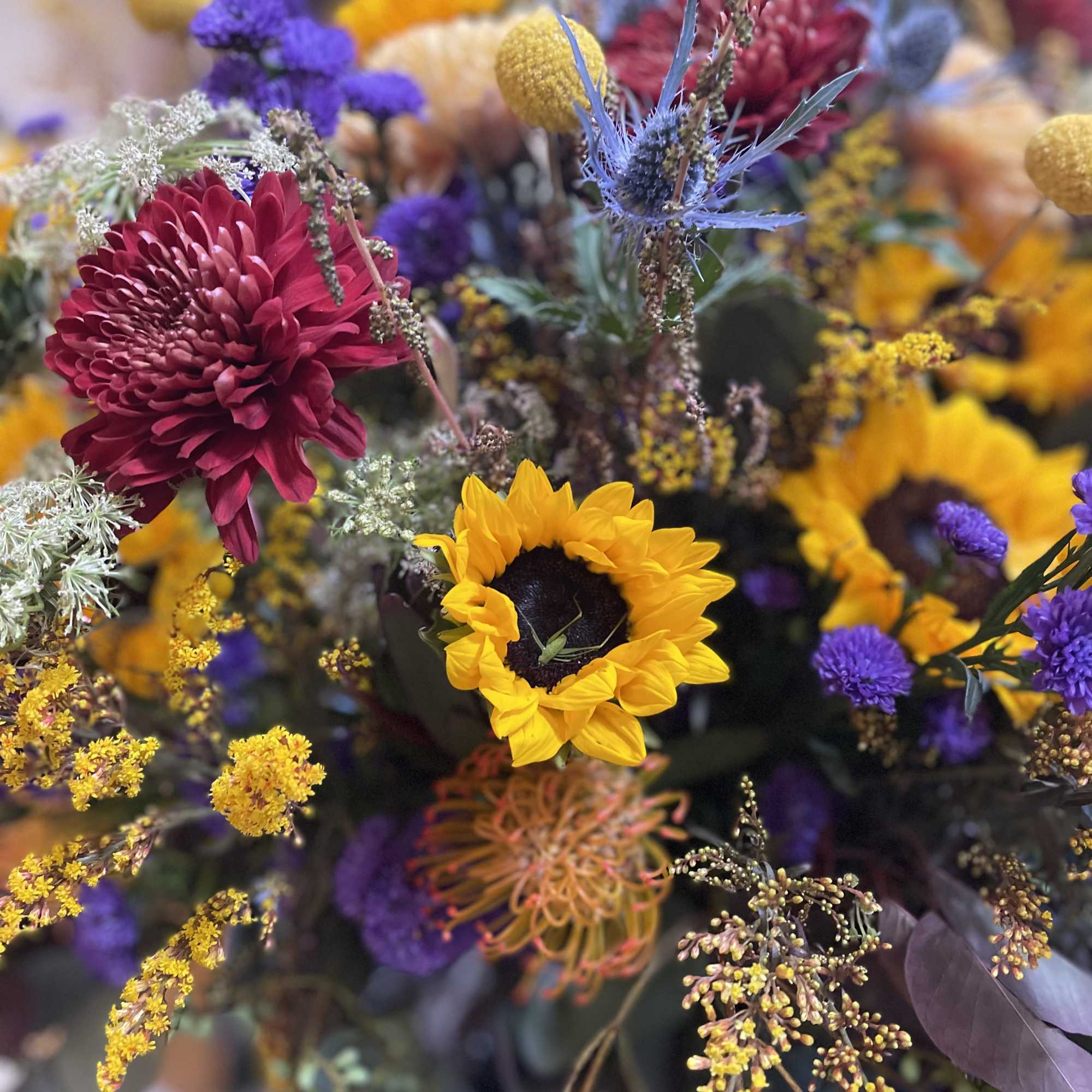 Yellow sunflowers, purple Saint Ann wildflowers, and eucalyptus create a stunning combination