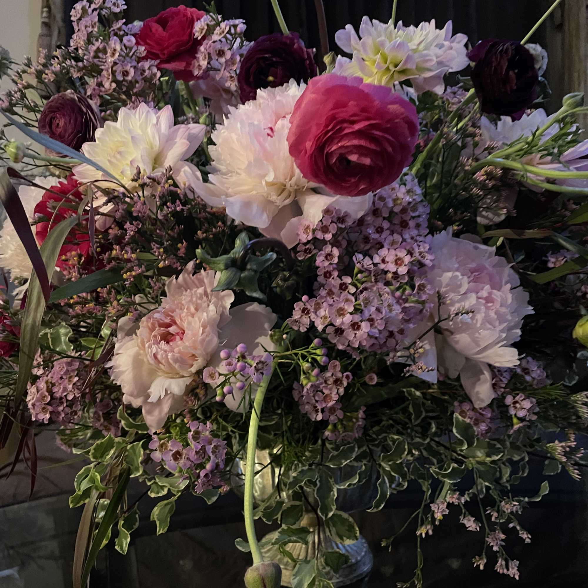 Marvelous seasonal floral arrangement with dahlias, ranunculus , peonies , and chrysanthemums.