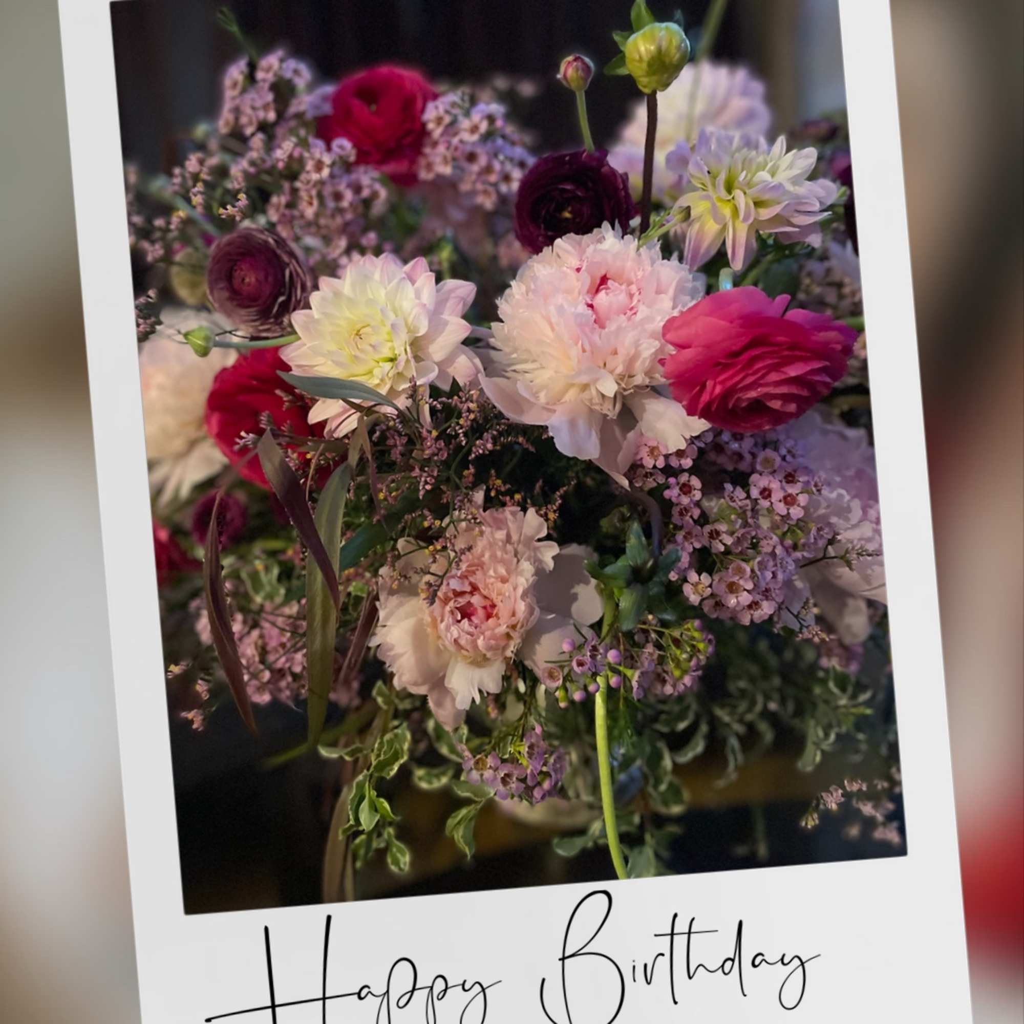 Marvelous seasonal floral arrangement with dahlias, ranunculus , peonies , and chrysanthemums.