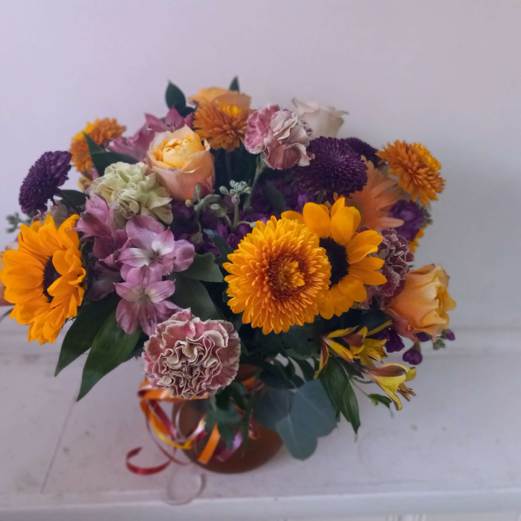Beautiful earthy and sunny colors flowers in vase arrangment