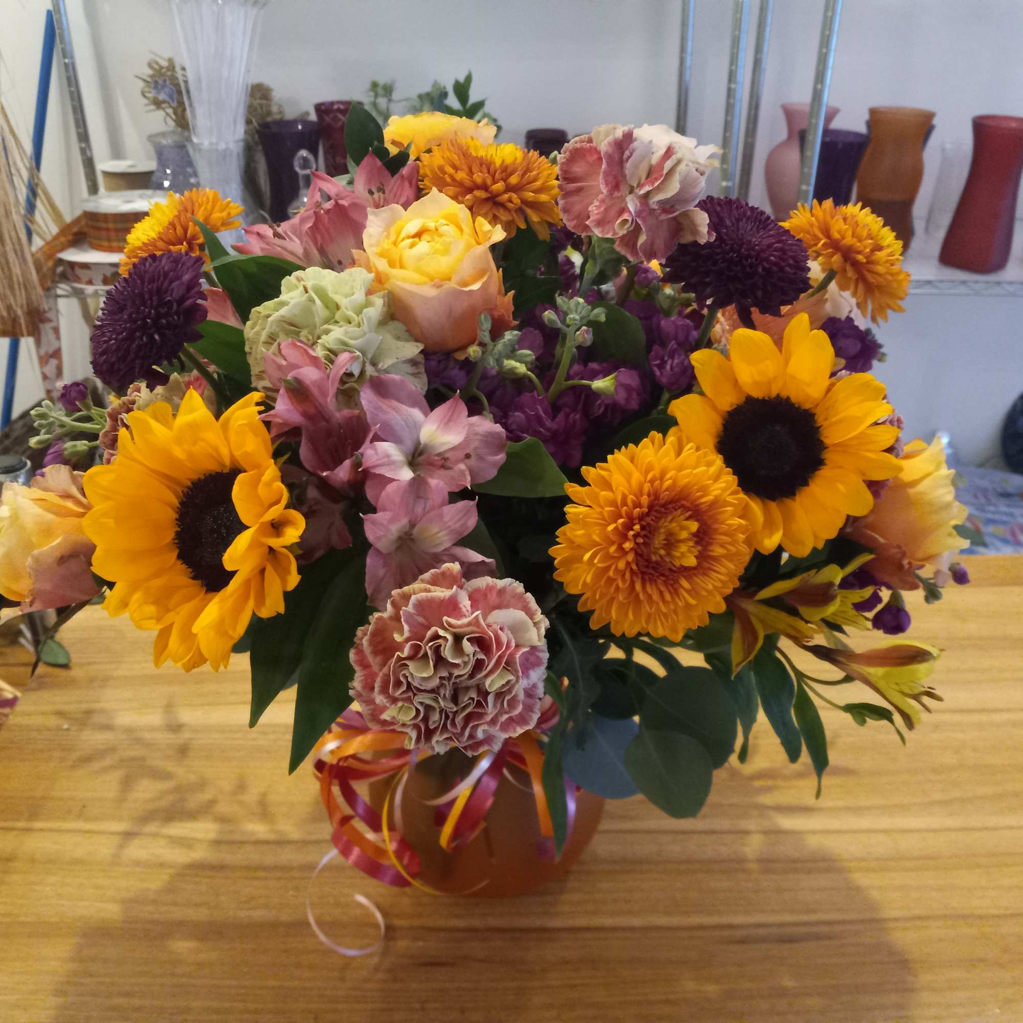 Beautiful earthy and sunny colors flowers in vase arrangment