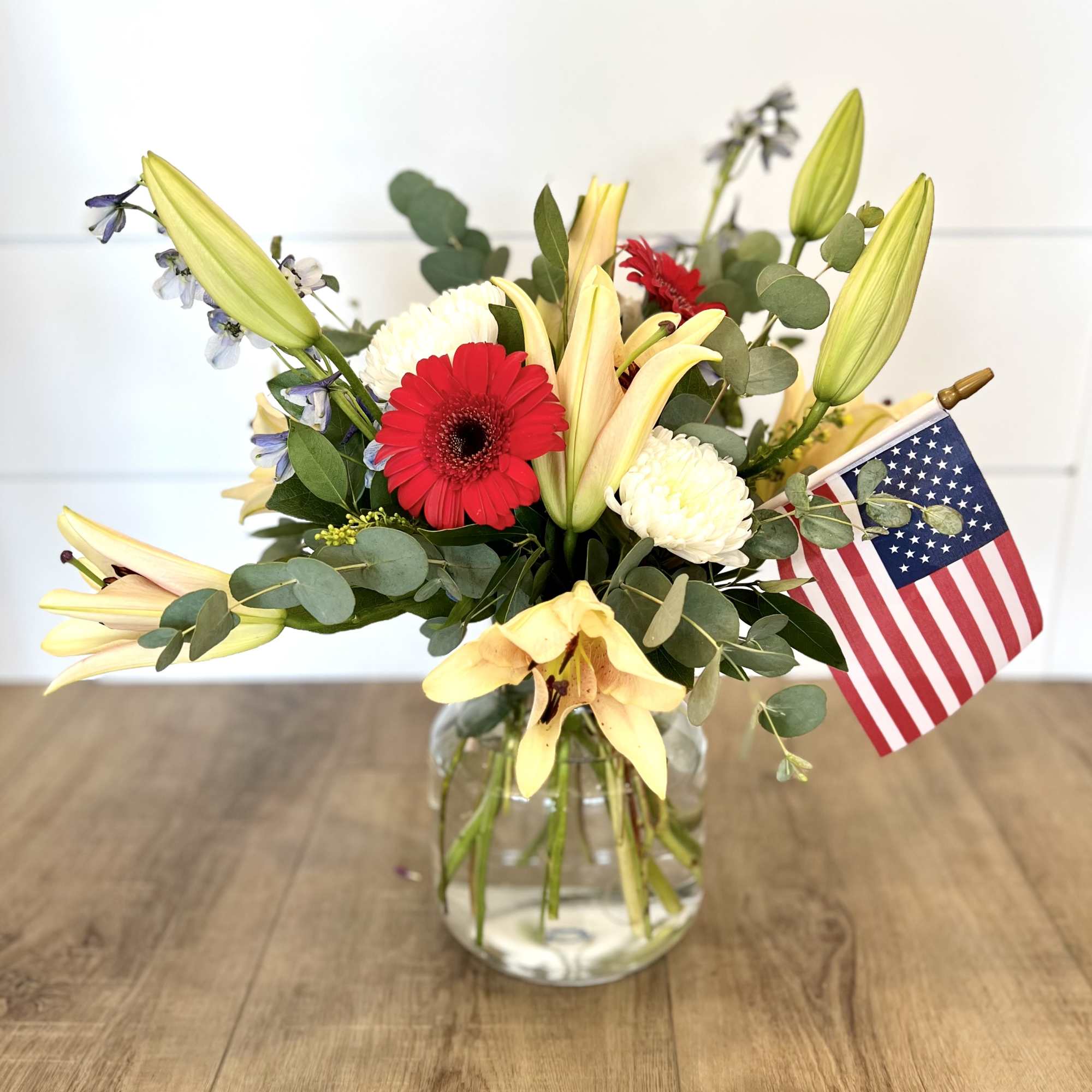 Featuring Gerber Daises, Lily&#039;s, and Blue Delphinium, 