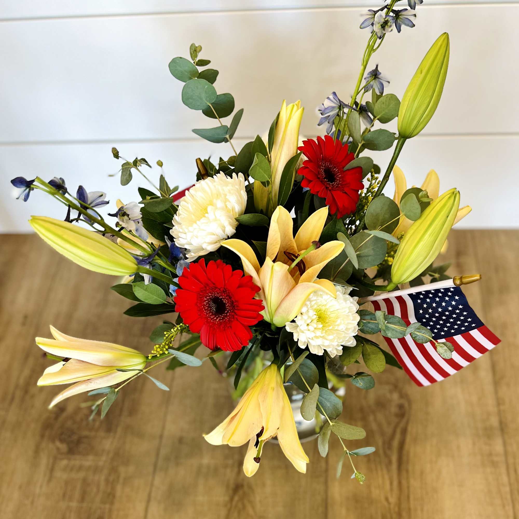 Featuring Gerber Daises, Lily&#039;s, and Blue Delphinium, 