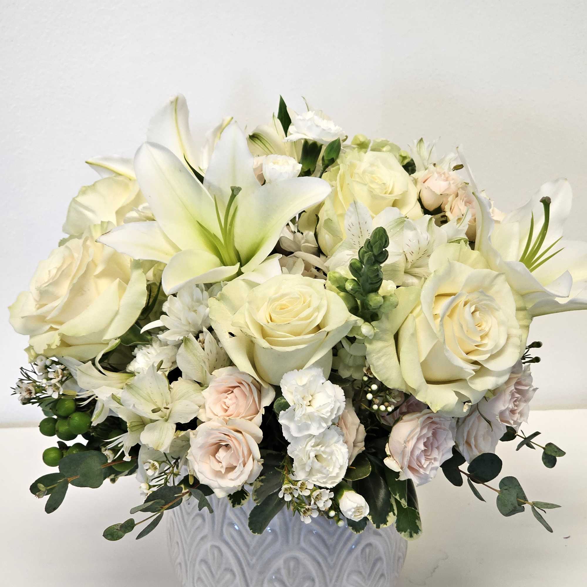 Embrace tranquility with our Beautiful Purple and White Breeze Arrangement, featuring a