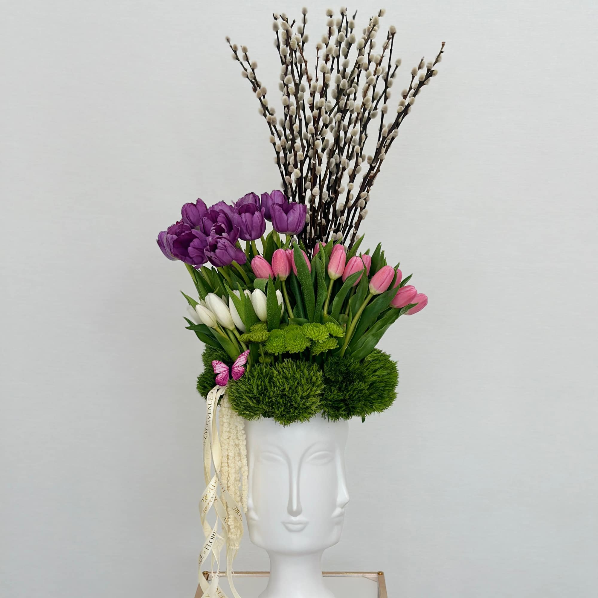 Introducing a chic vase adorned with a delightful arrangement of purple, pink