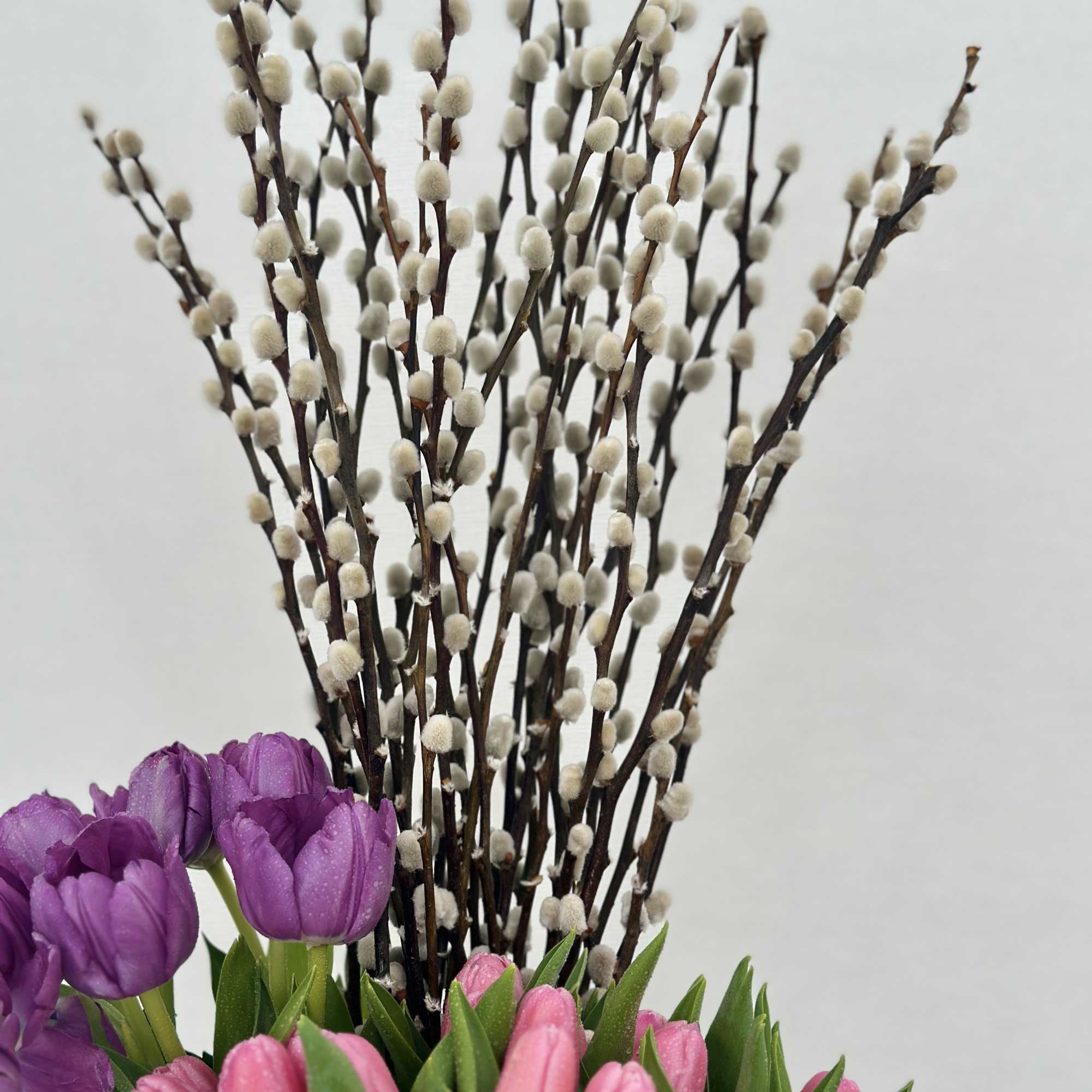 Introducing a chic vase adorned with a delightful arrangement of purple, pink