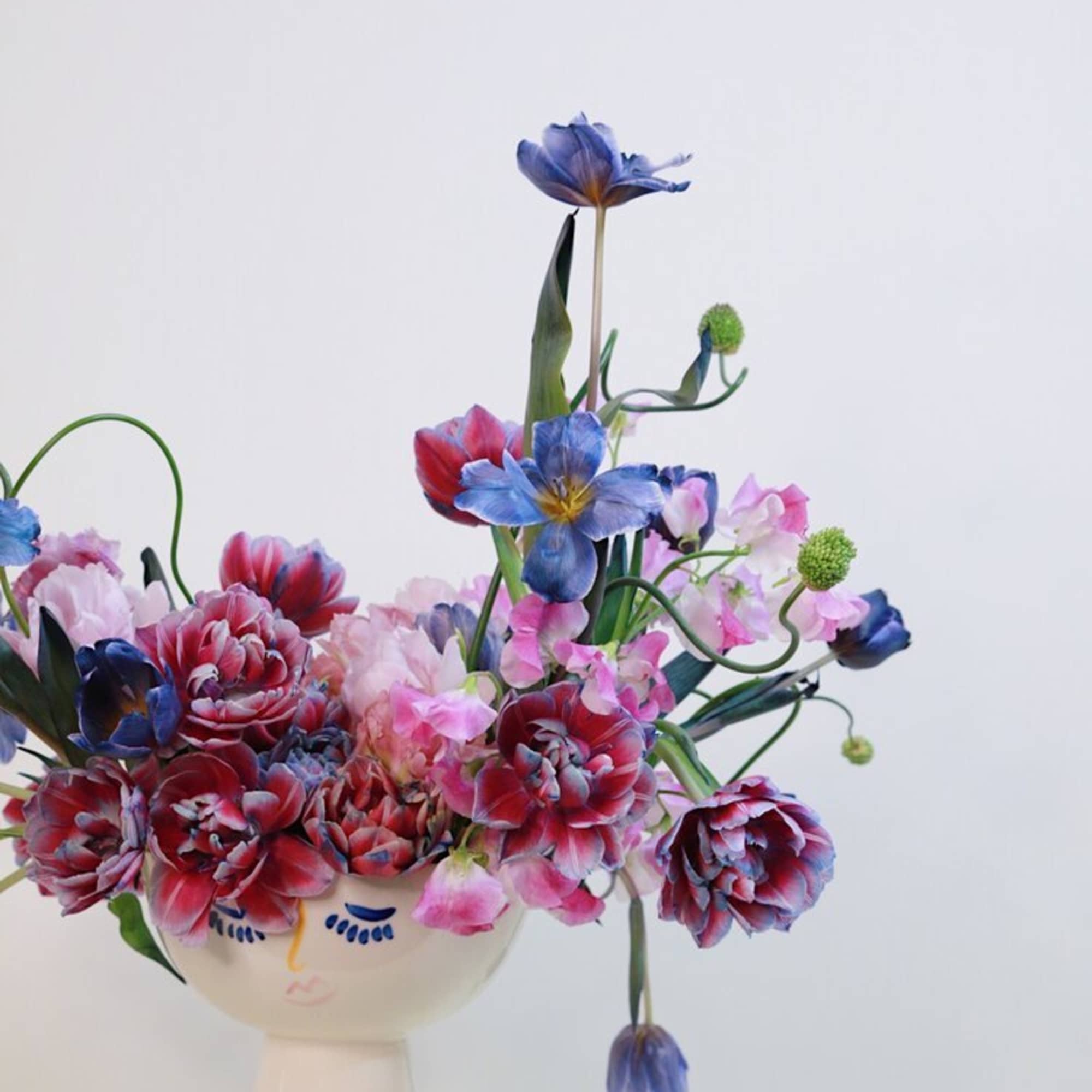 - Blooms with captivating mix of deep-toned, vibrant multicolored tulips
- Creates a