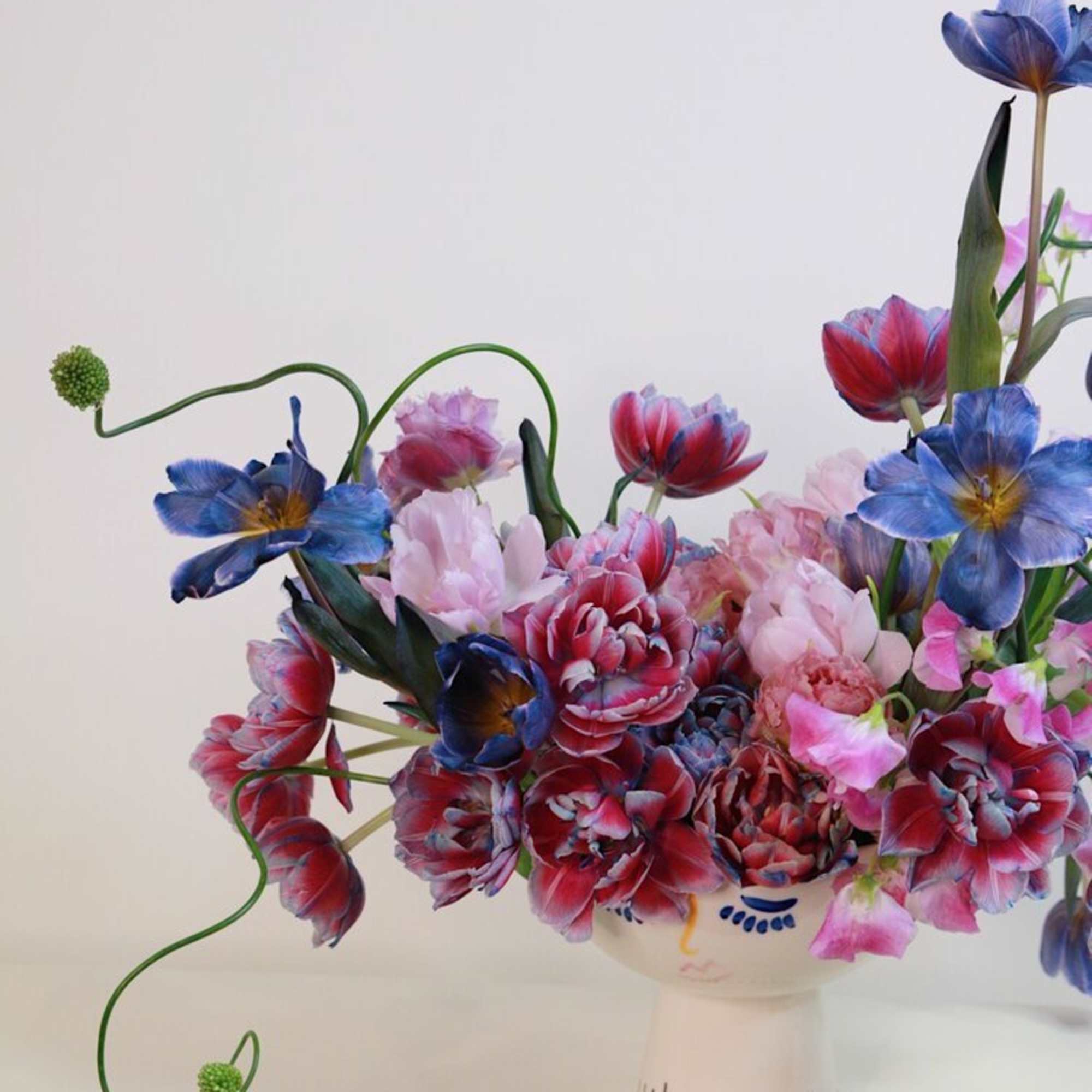 - Blooms with captivating mix of deep-toned, vibrant multicolored tulips
- Creates a