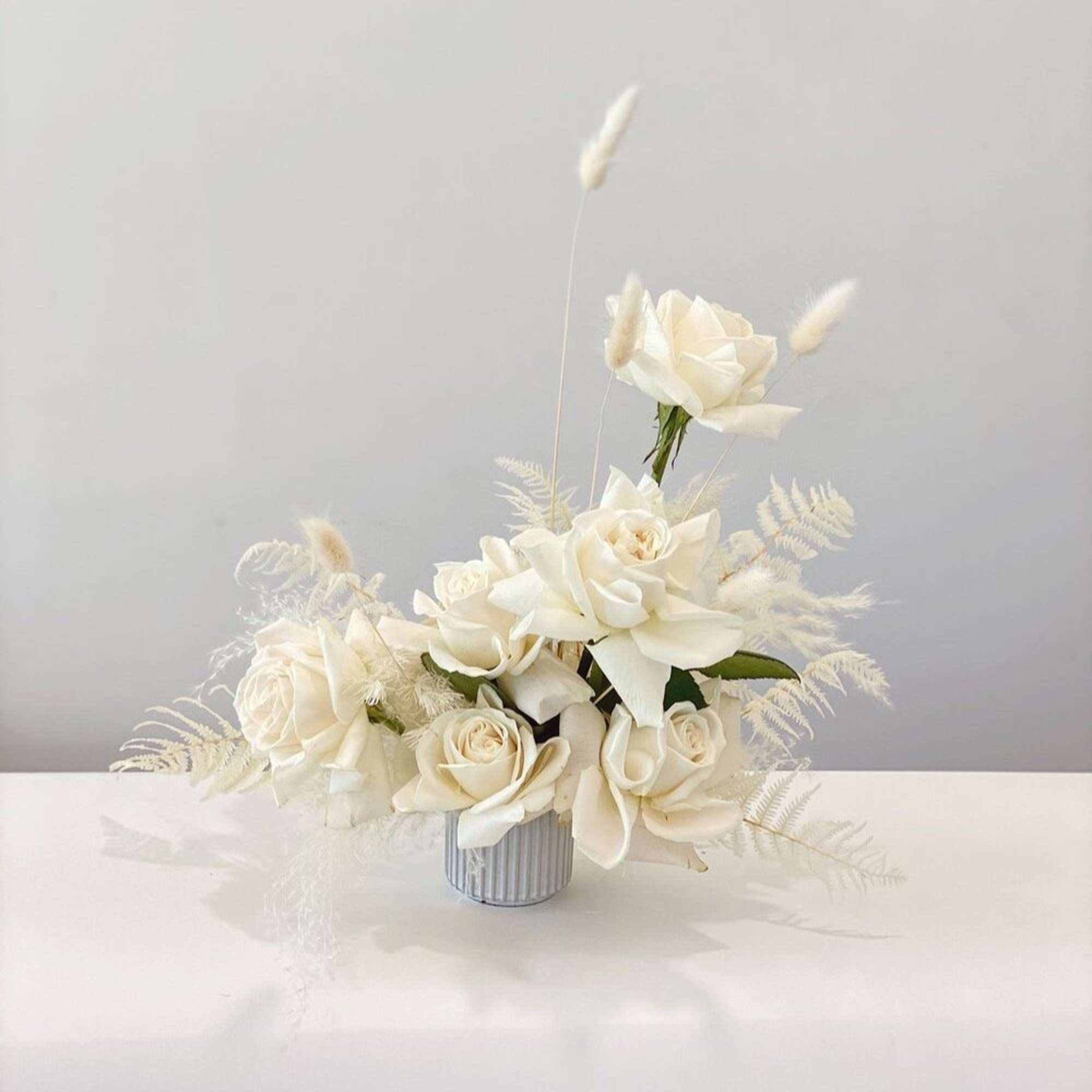 - Epitomizes elegance with a purely white composition
- Features exquisite roses, delicate