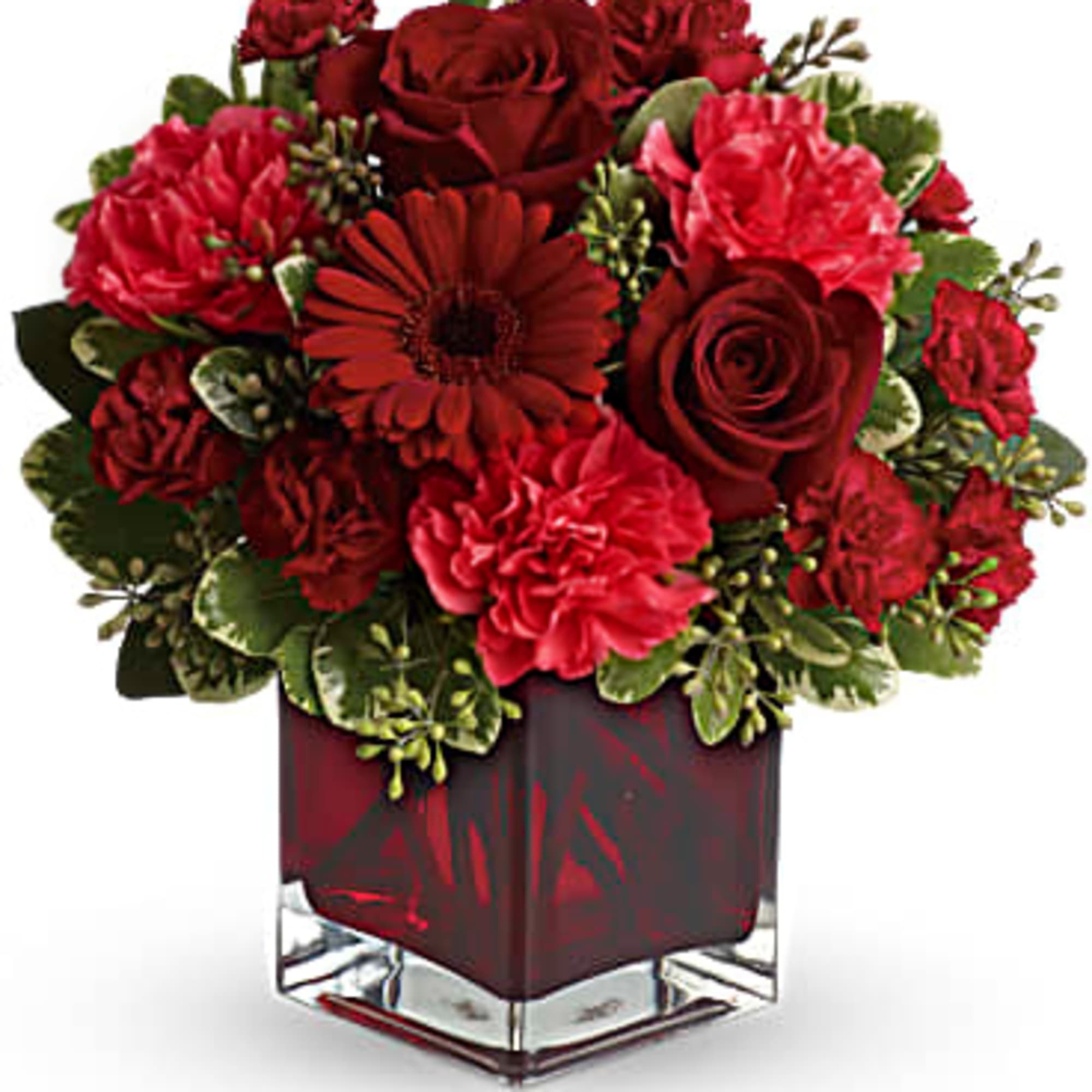 A mix of roses, carnations and more in shades of red accented