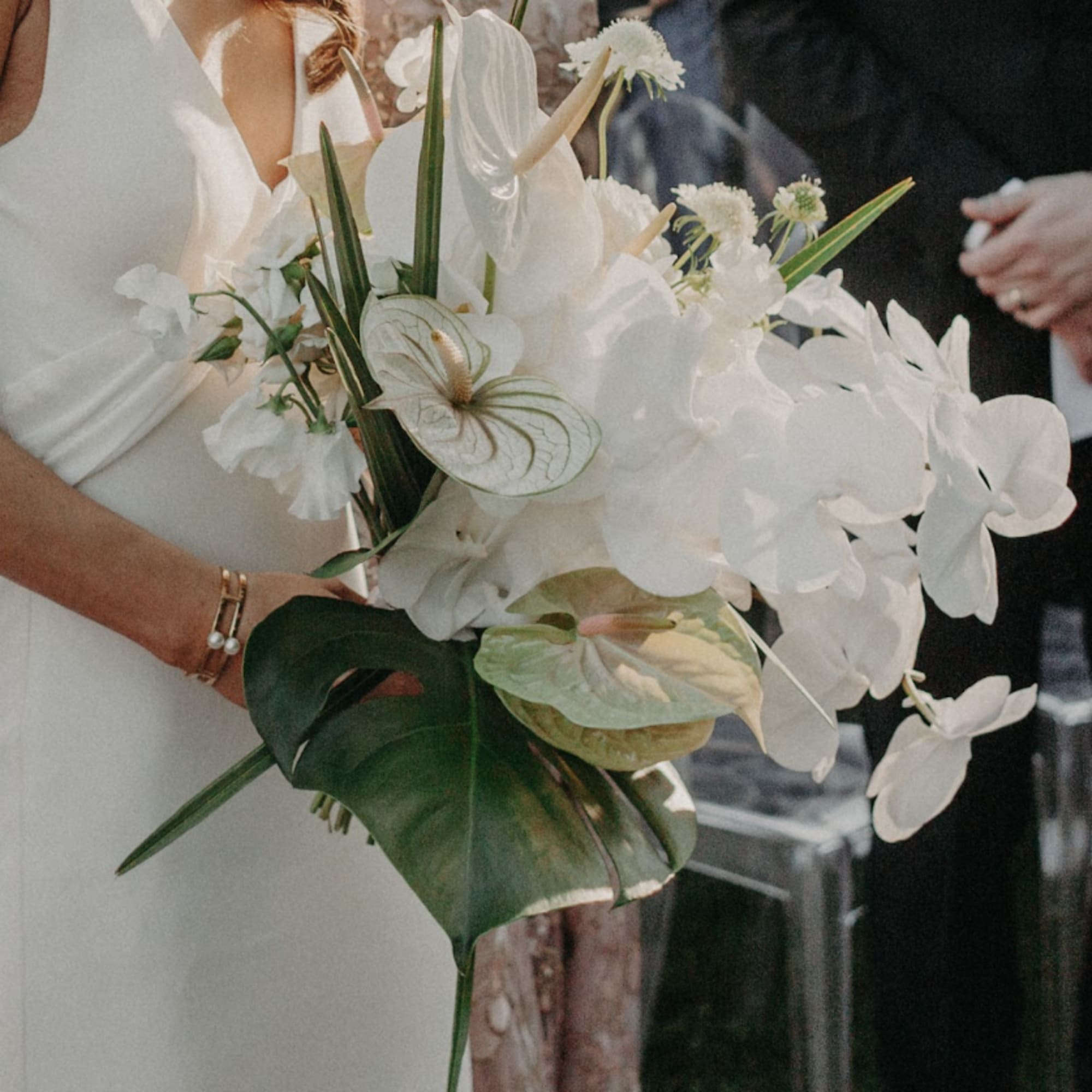 - Stunning bridal bouquet blending crisp whites and lush greens with a