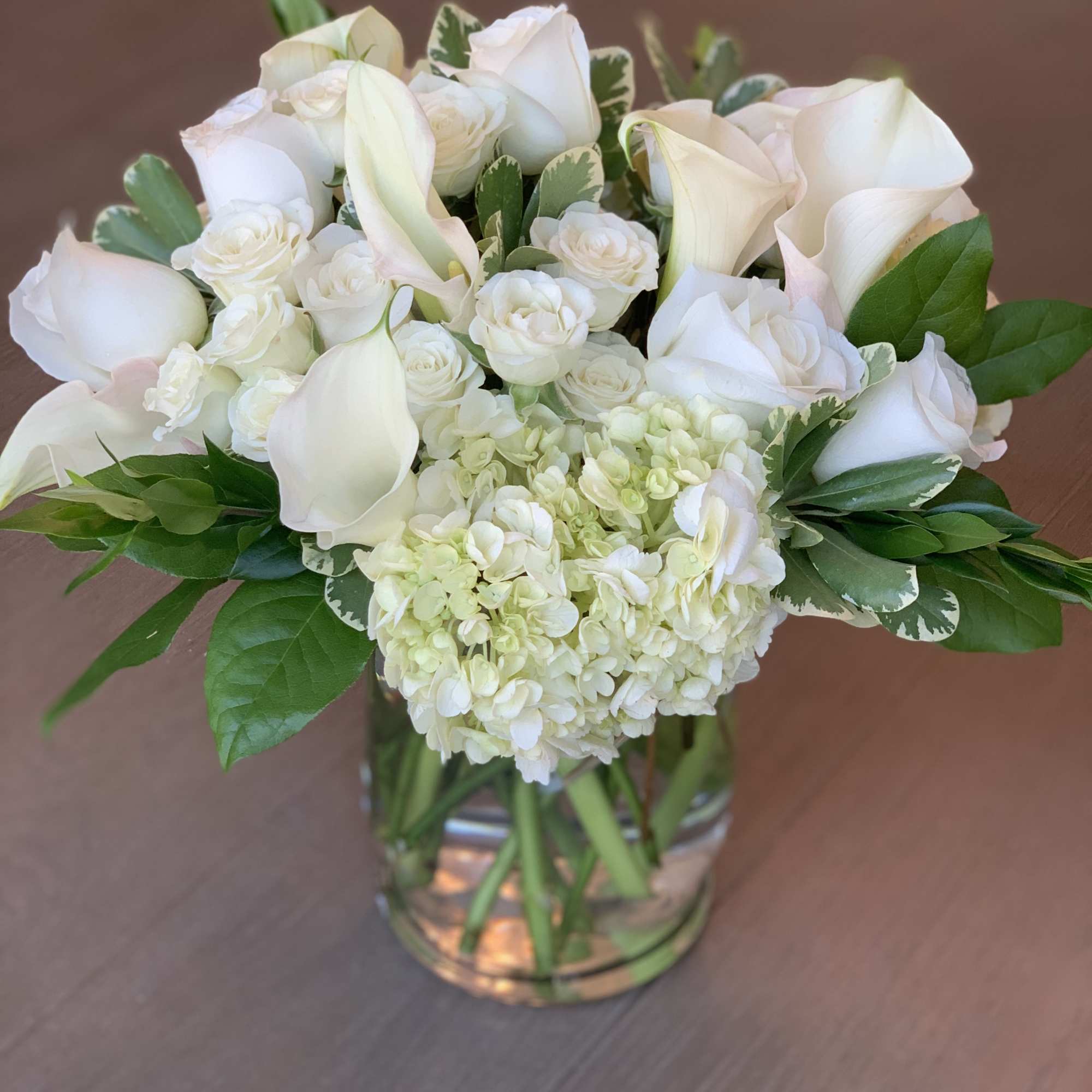 White roses, accent flowers, and greens  White roses, accent flowers, and greens