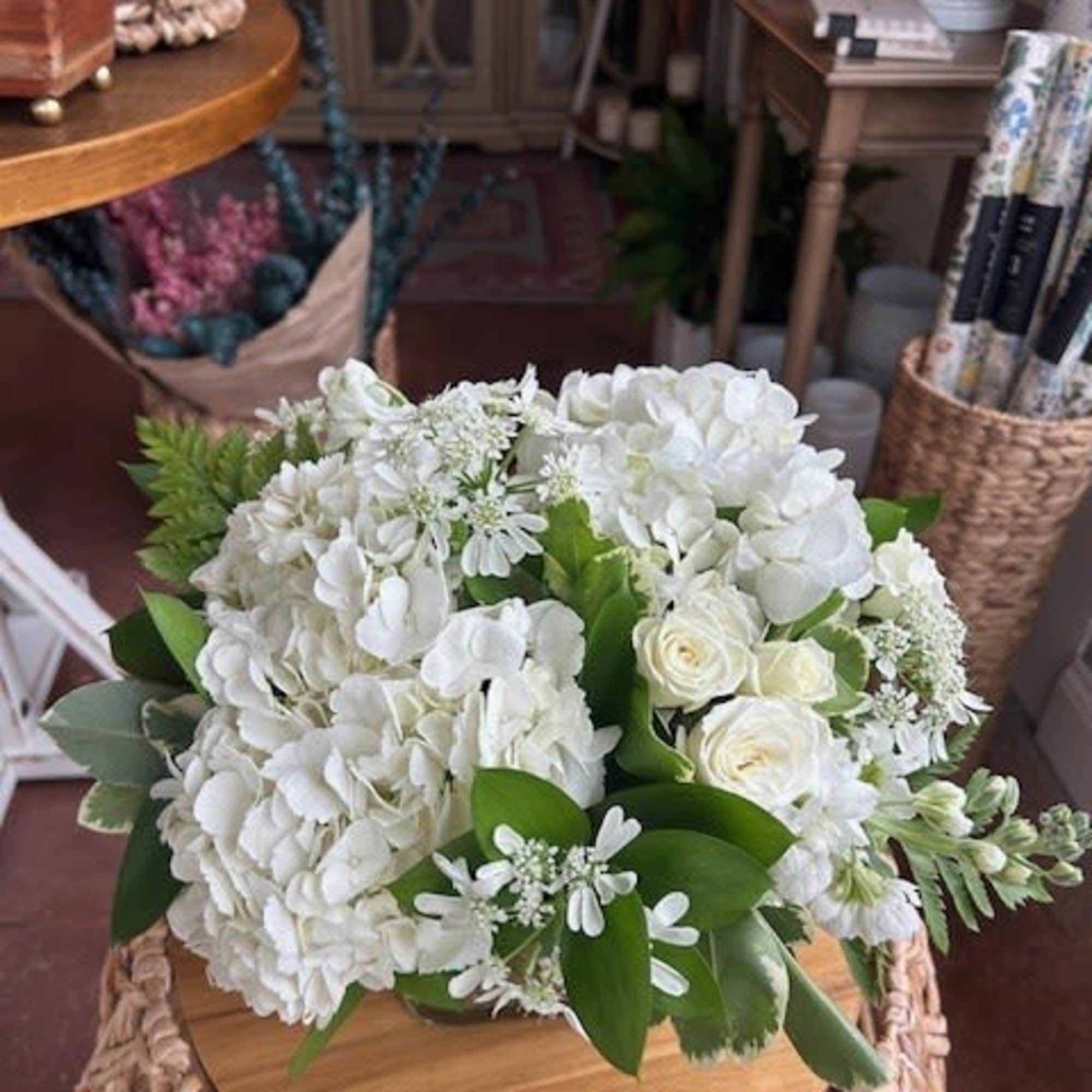 White roses, accent flowers, and greens  White roses, accent flowers, and greens