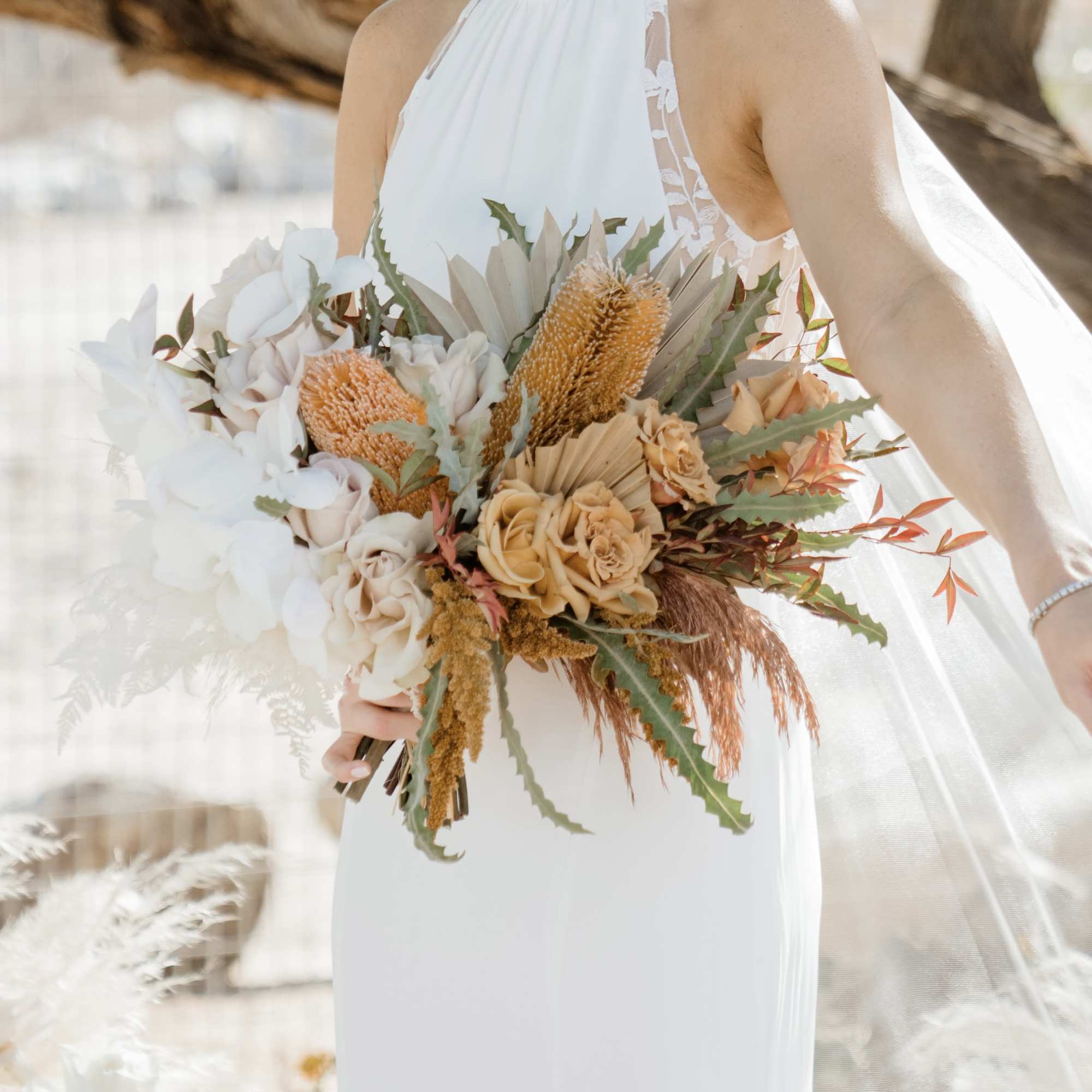- Showcase rustic elegance with a bouquet in pale orange, soft white