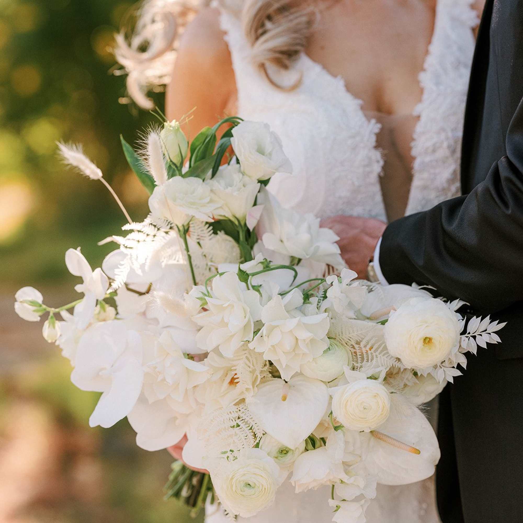- Effortlessly elegant with a light, airy arrangement
- Pure white blooms accented