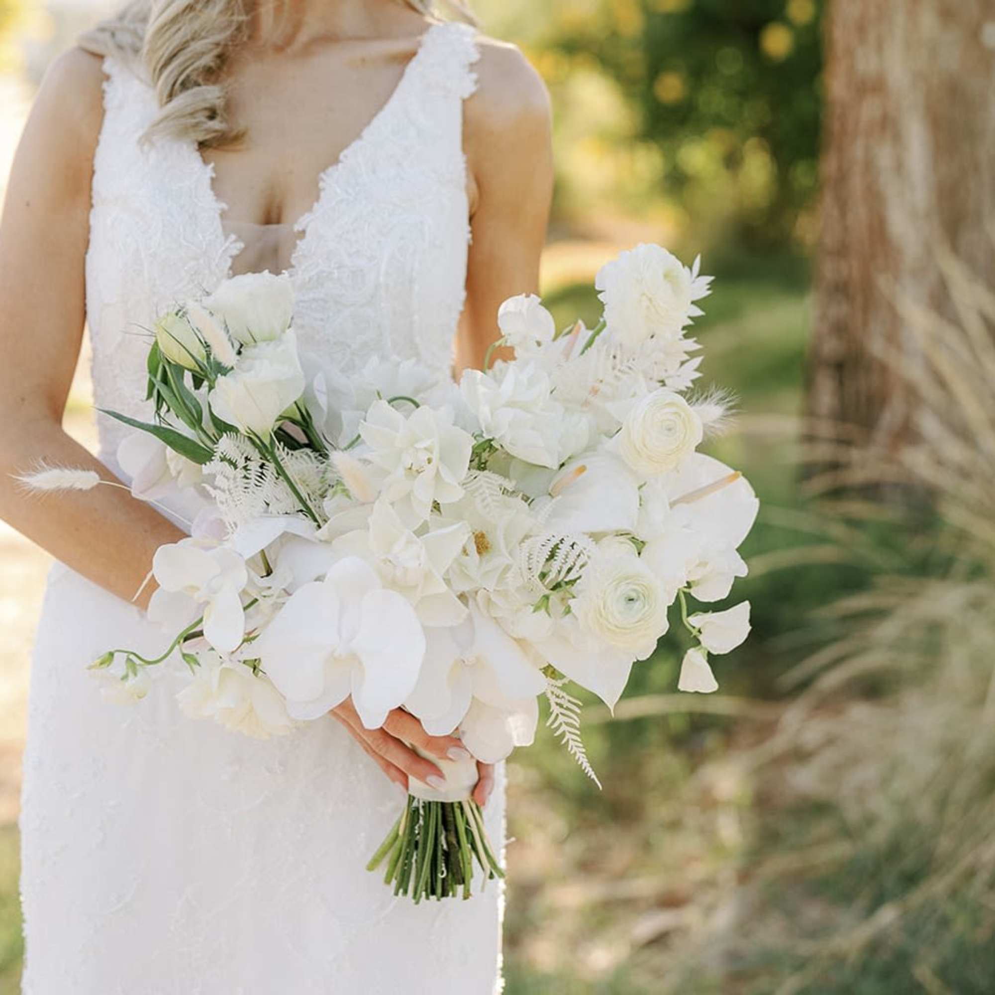 - Effortlessly elegant with a light, airy arrangement
- Pure white blooms accented