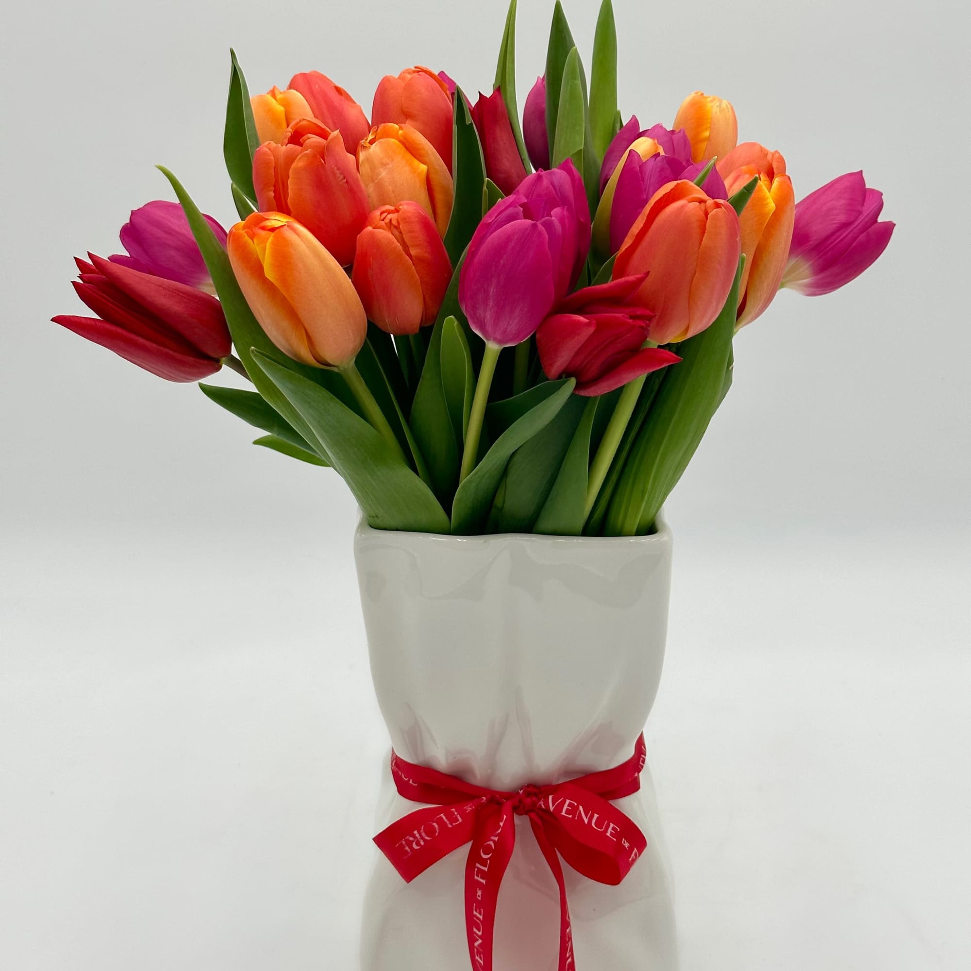 This unique arrangement harmoniously blends the natural beauty of tulips captured within