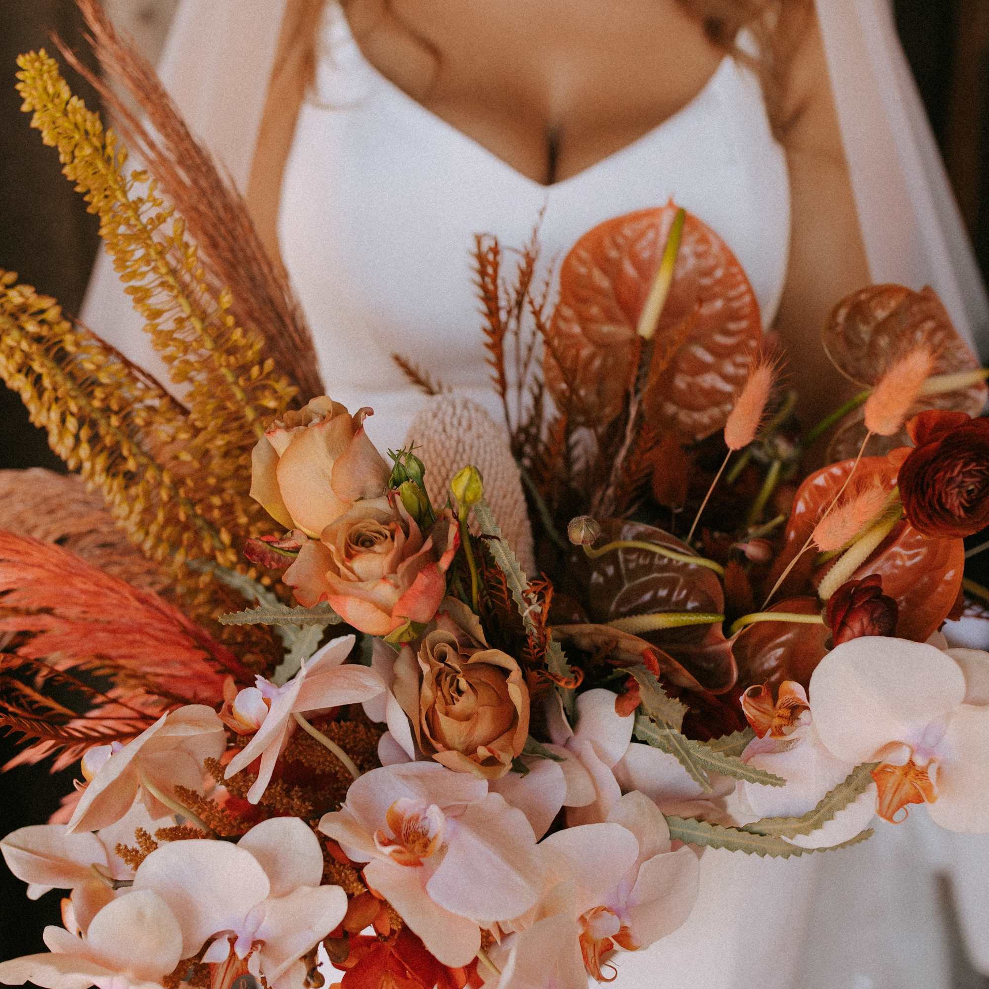 -  Bridal bouquet showcasing warm and peach tones
- Earthy, organic arrangement