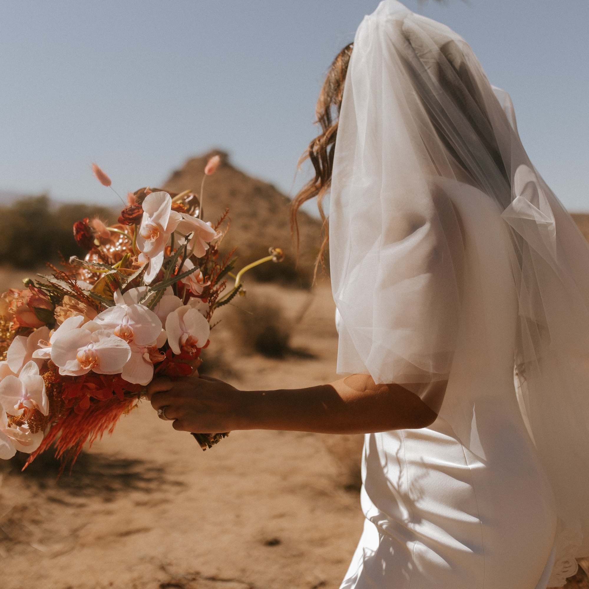 -  Bridal bouquet showcasing warm and peach tones
- Earthy, organic arrangement