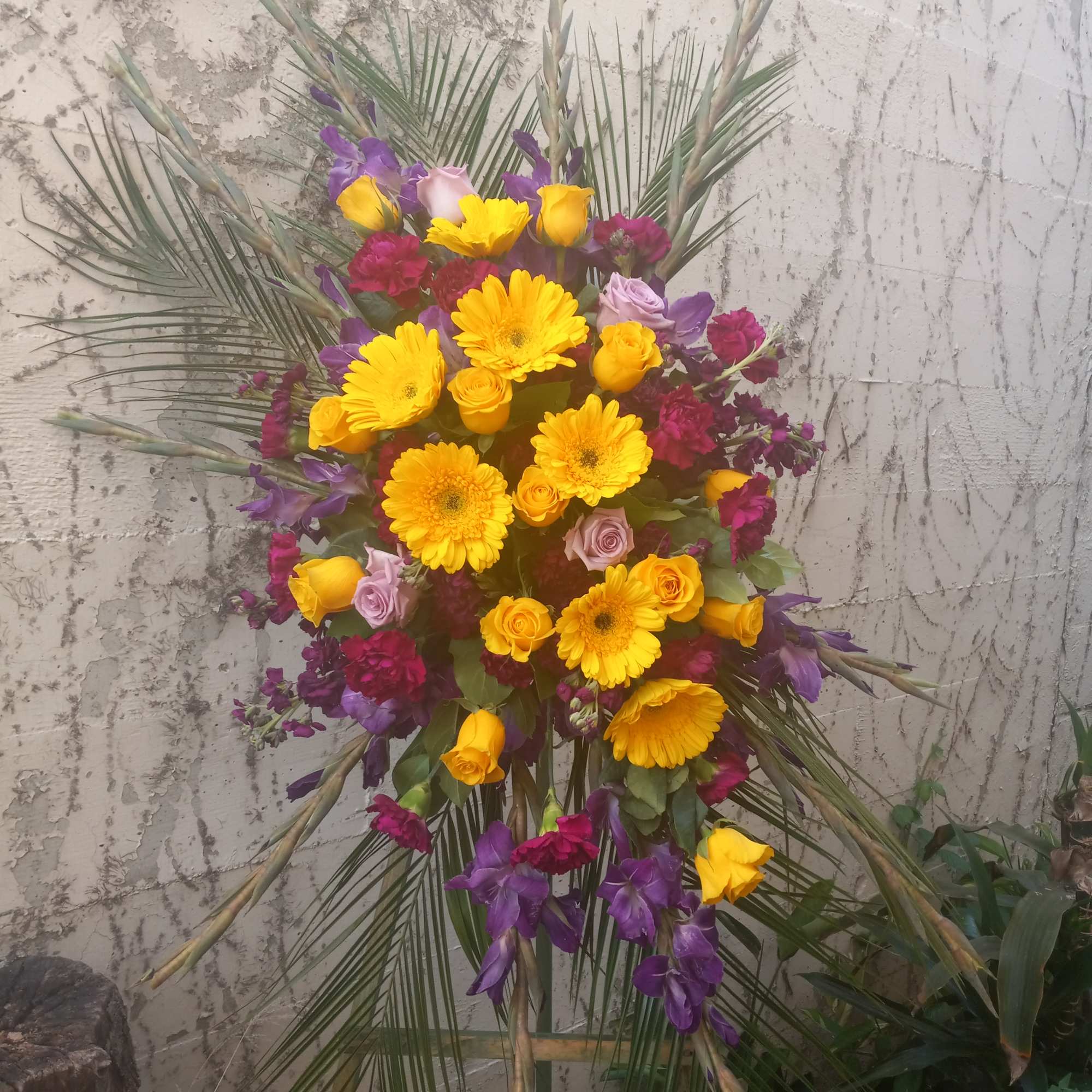 This bright and vibrant spray has purple carnations, gladiolus and stock. The