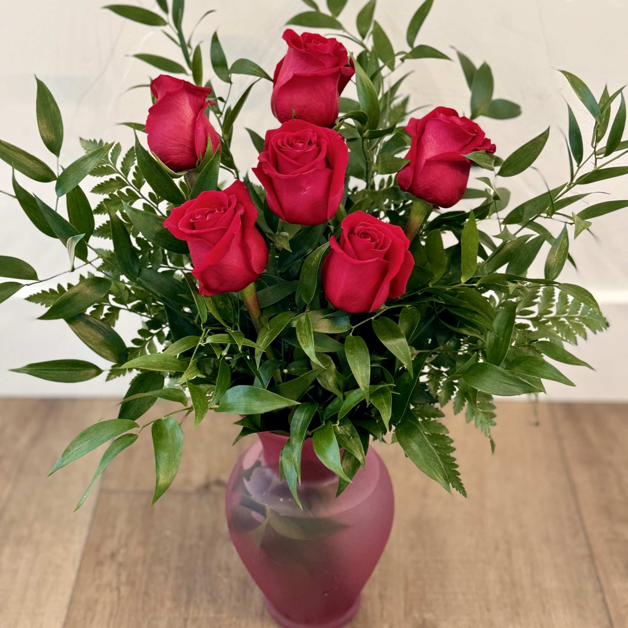 1/2 Dozen beautiful roses arranged in a vase with fill. 