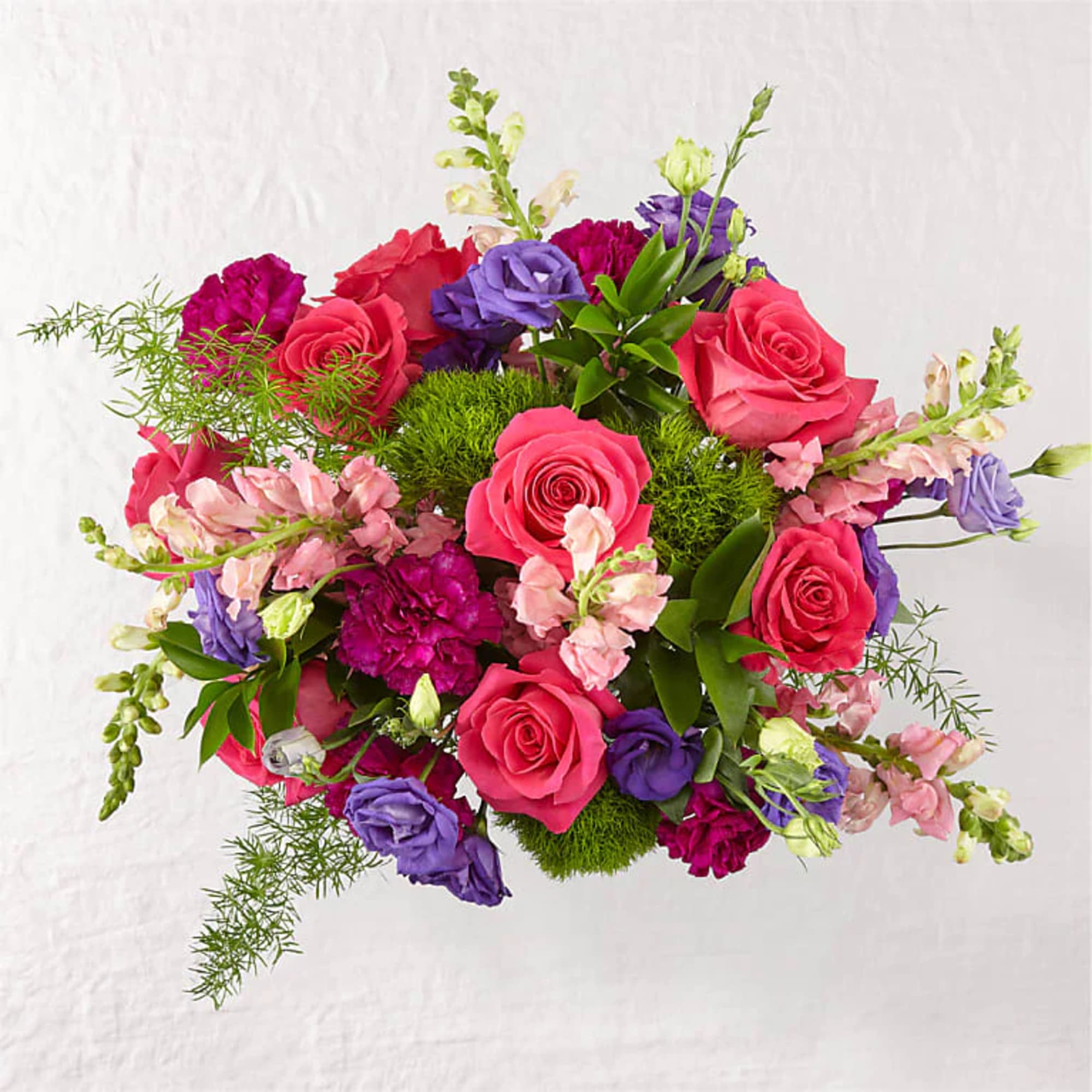 Roses and snapdragons add gorgeous texture to complement the blooms in this