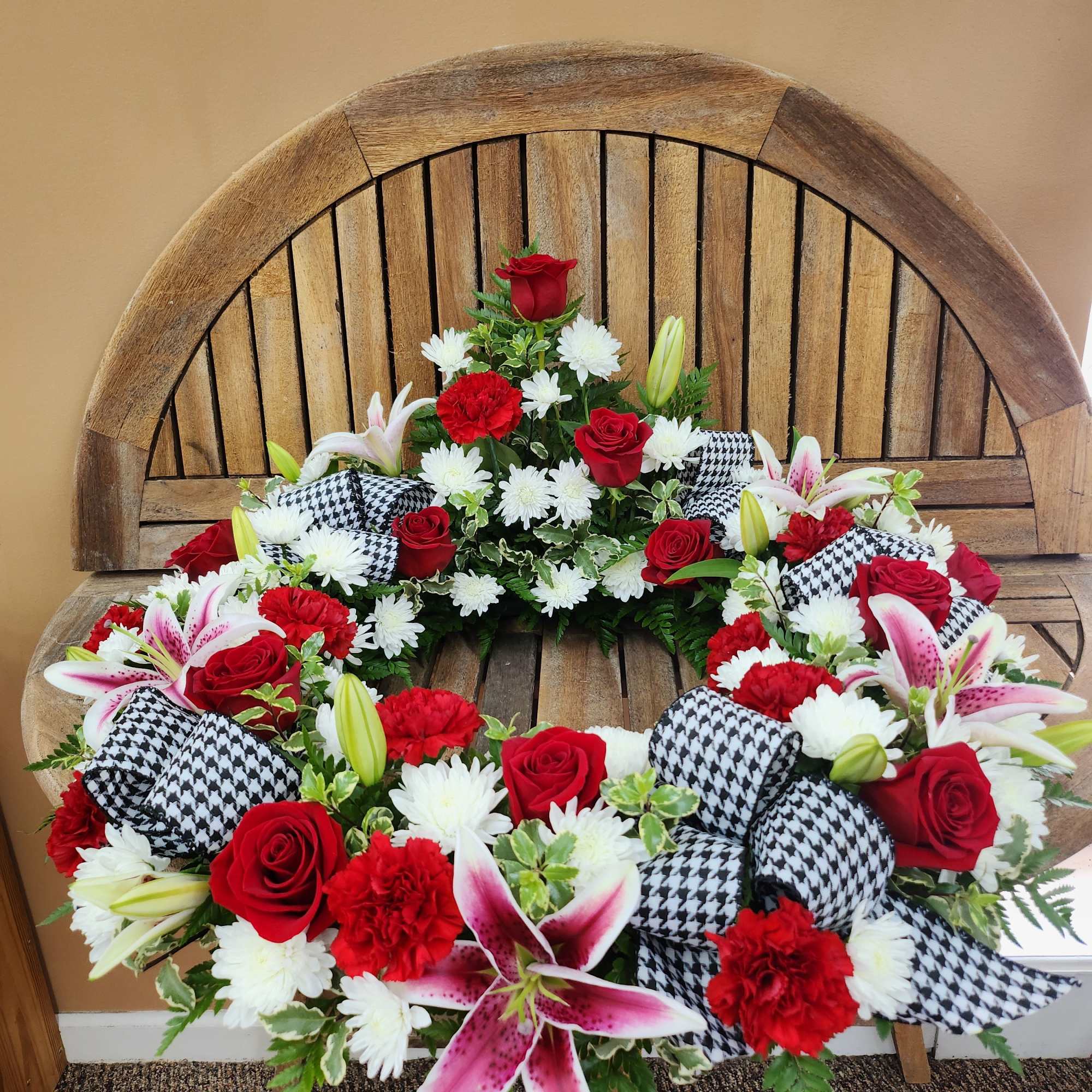 Urn wreath in reds and whites with Houndstooth ribbon. CHERUB NOT INCLUDED.