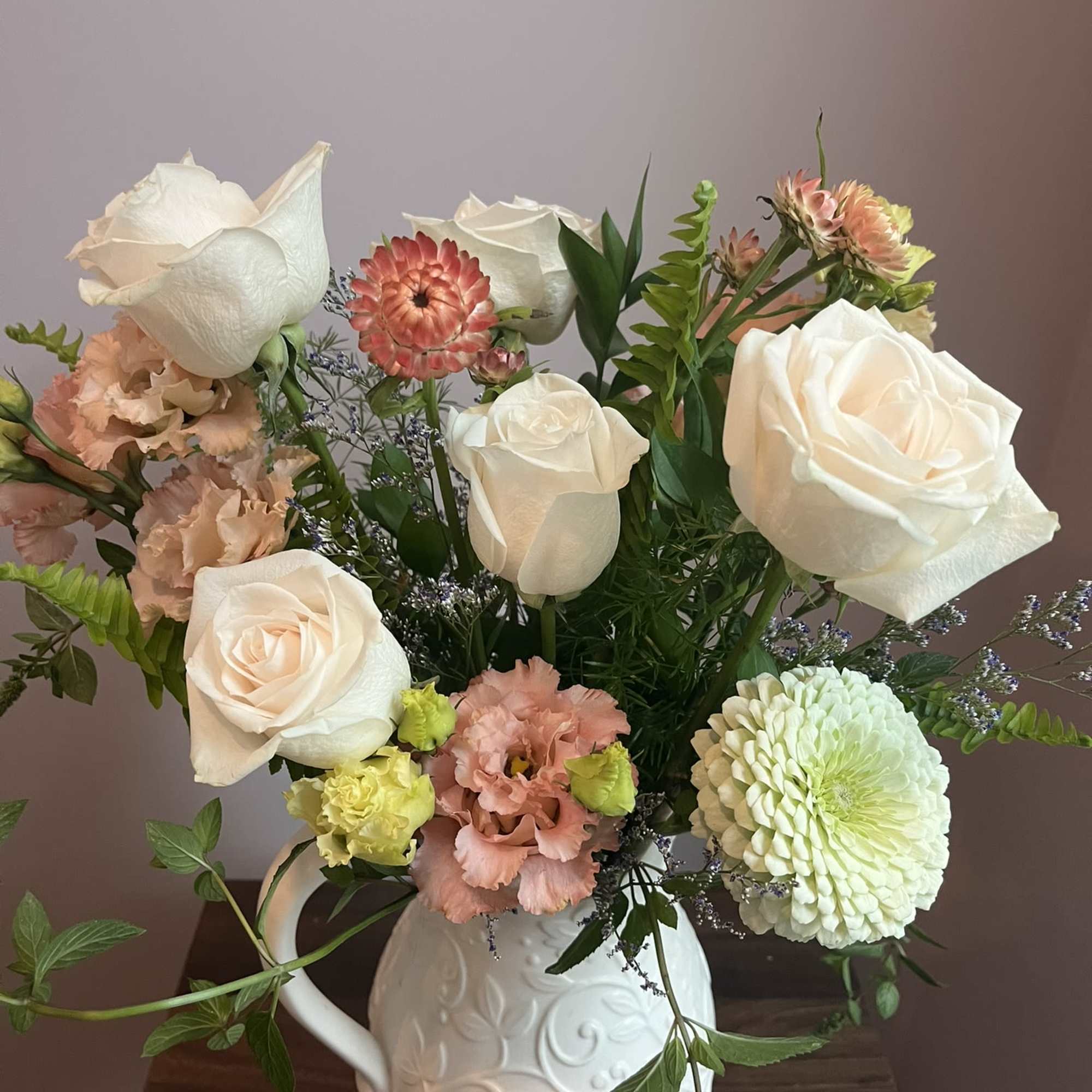 This is a medium height arrangement filled with white and pastel colors. This is a medium height arrangement filled with white and pastel colors.