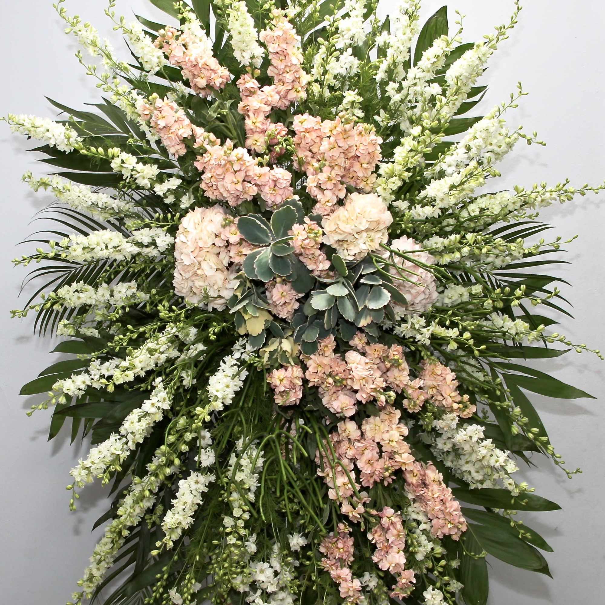 This spray is made with white and pink florals. 

We include easel
