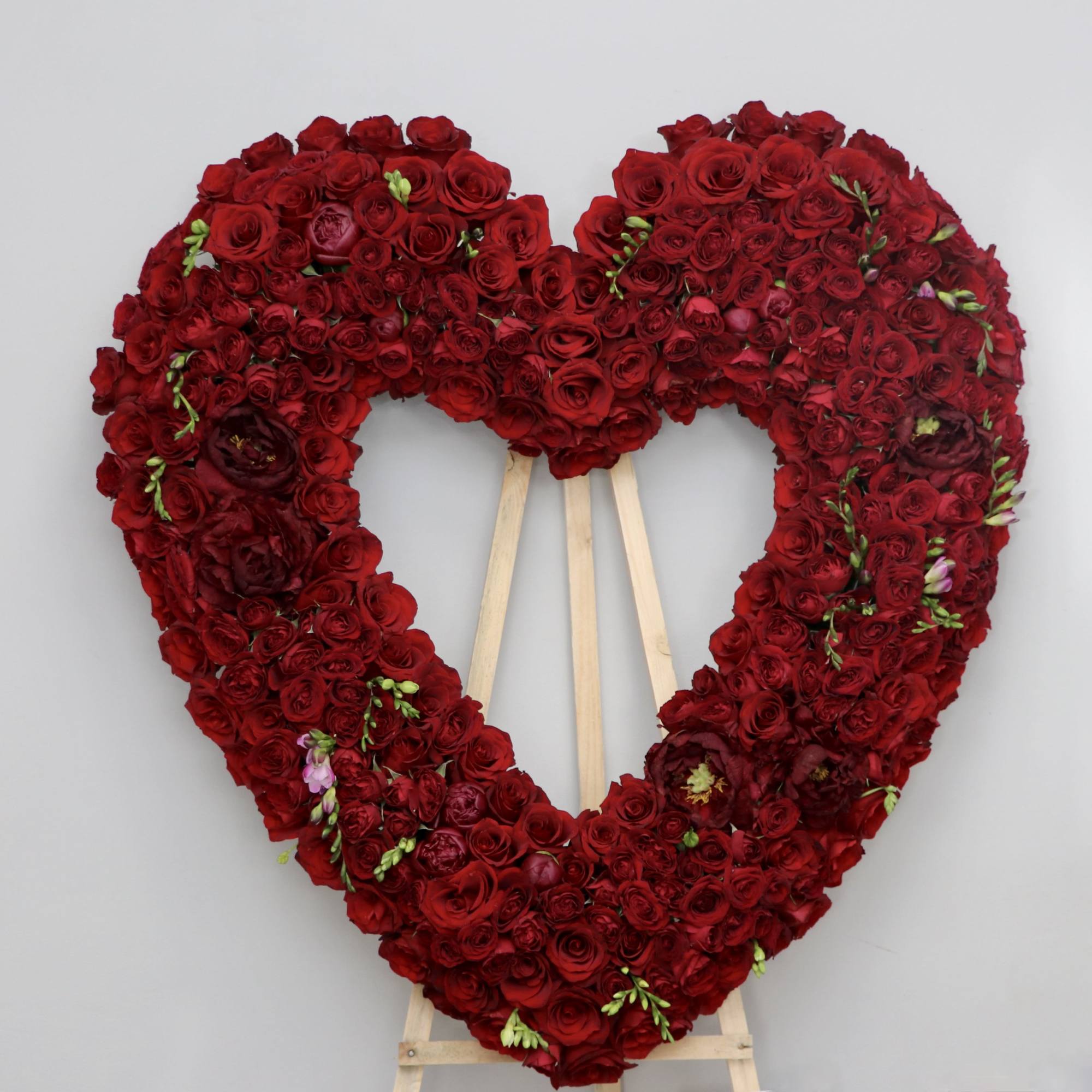 This sympathy heart made with all red roses and florals.
(Photo shows PREMIUM